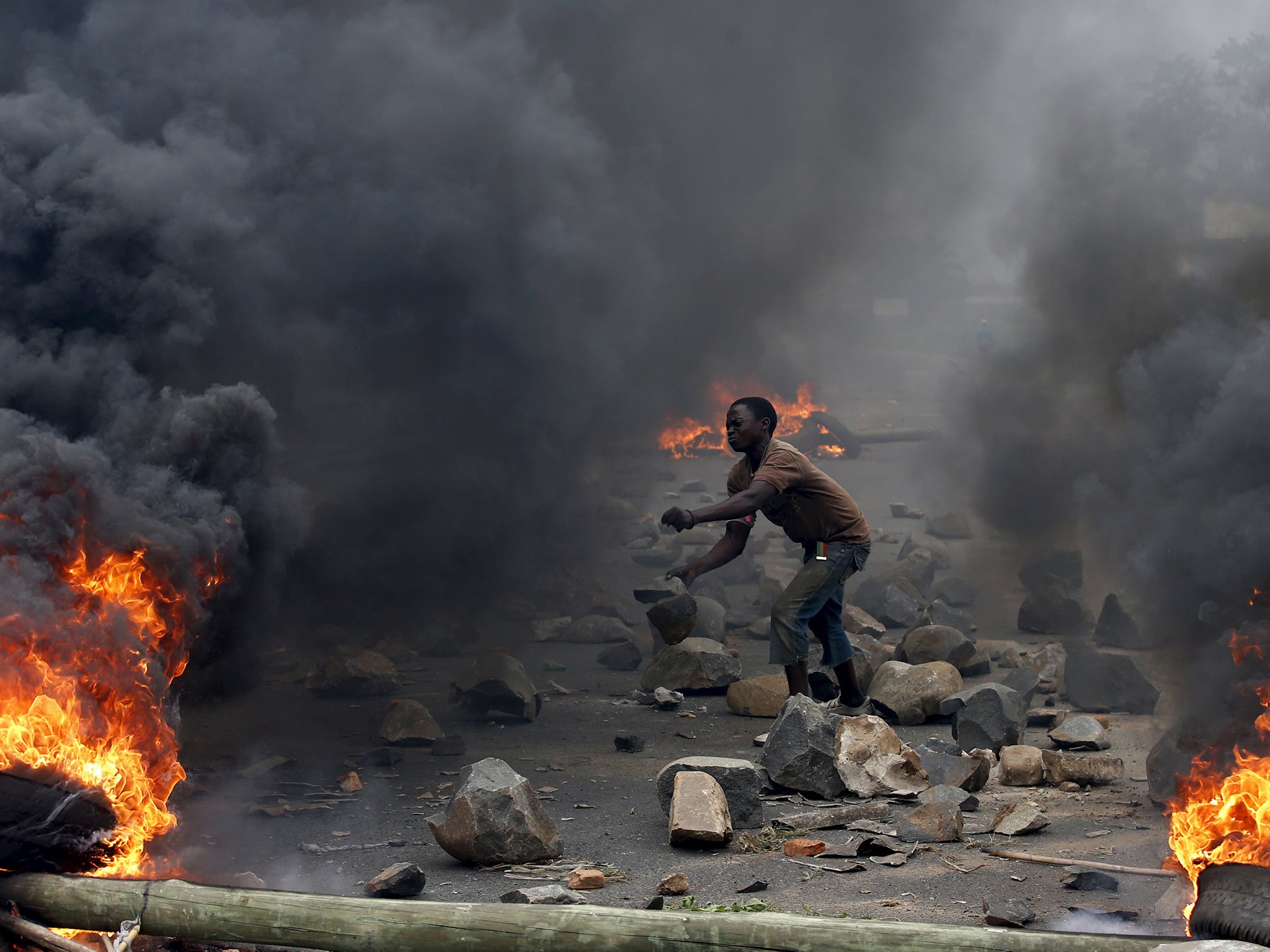 A protester sets up a barricade during a protest against Burundi President Pierre Nkurunziza