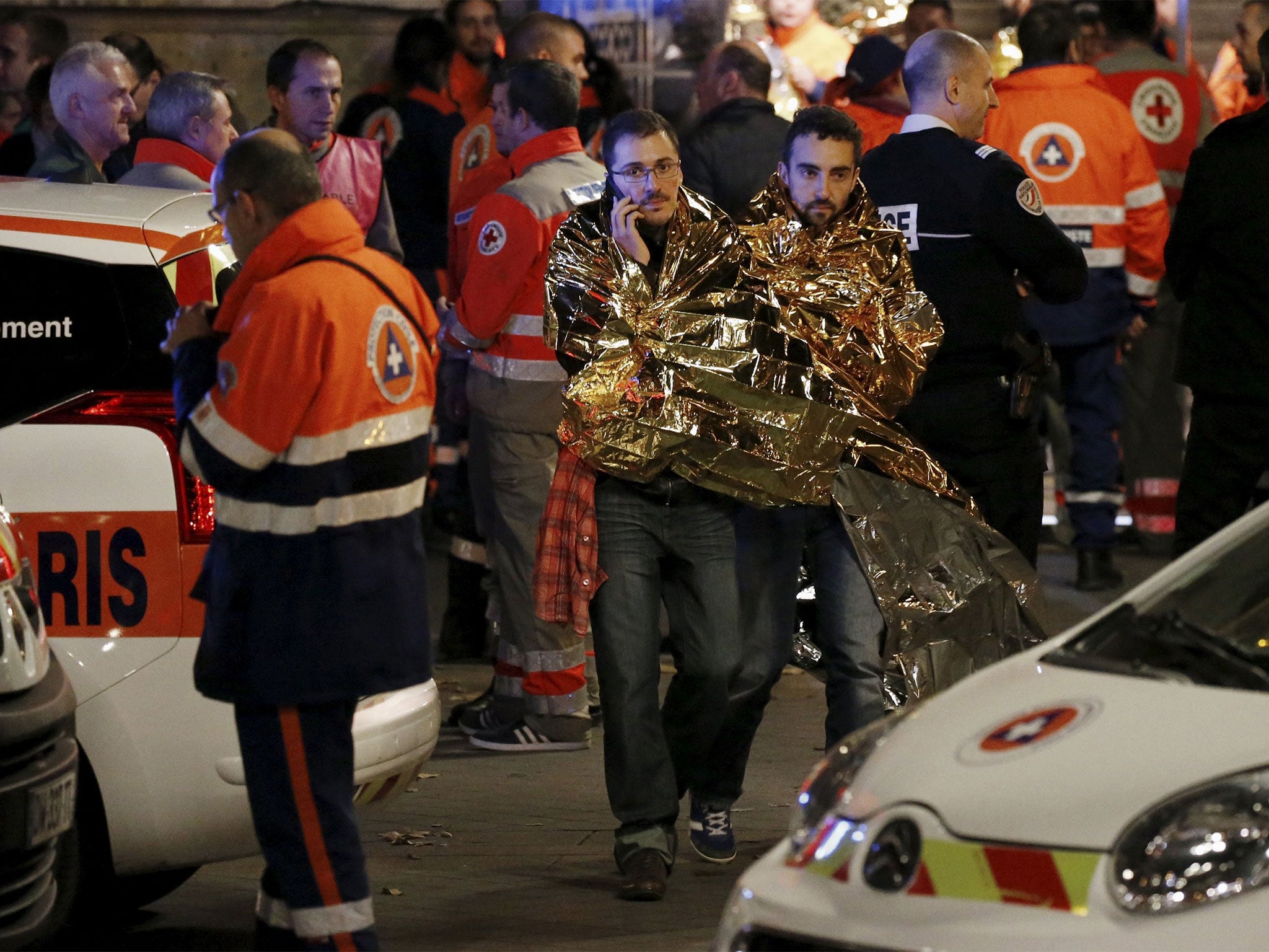 Survivors outside the Bataclan theatre, where 89 people were killed