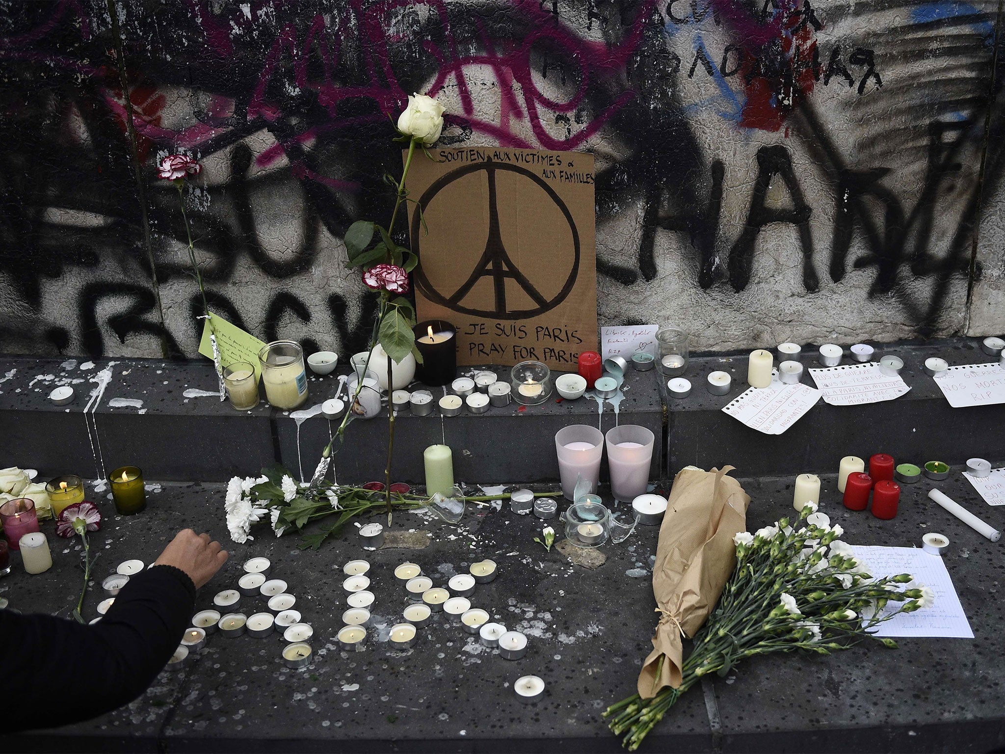 Parisians lay flowers at the Place de la Republique