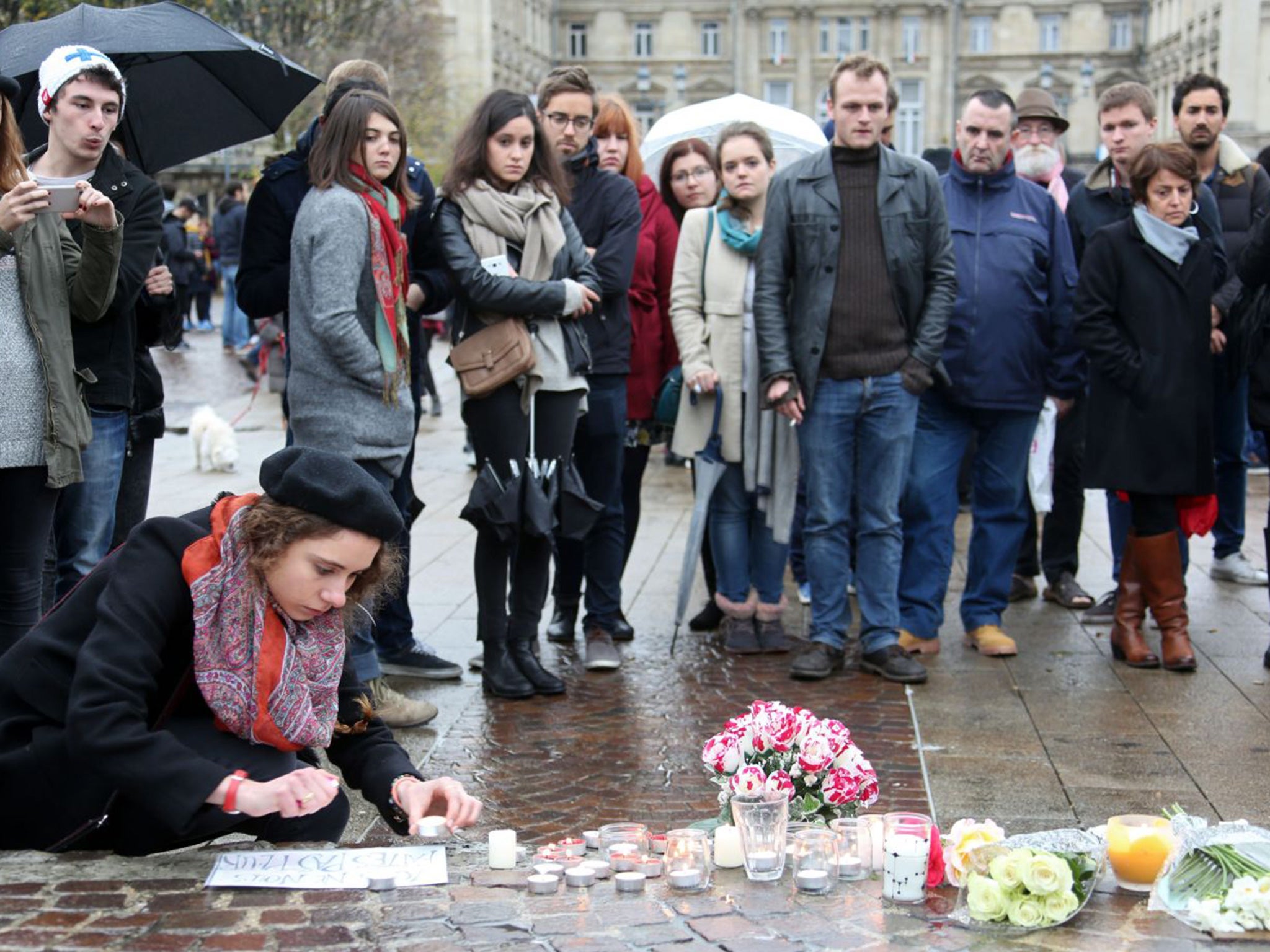 People light candles at a makeshift memorial in Lille, northern France,to pay tribute to the victims of the terror attack in Paris