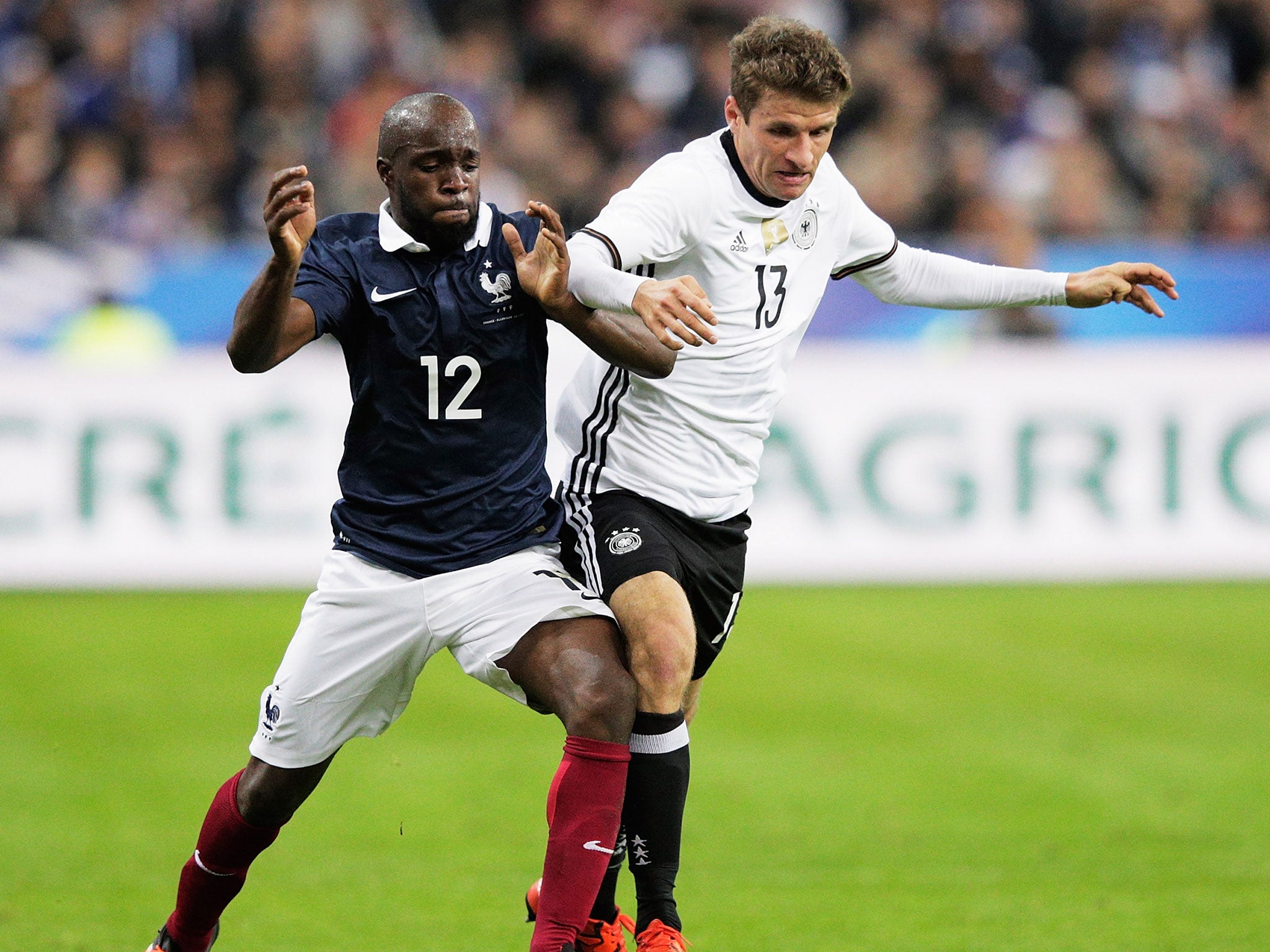 Lassana Diarra (L) tussles with Thomas Muller of Germany