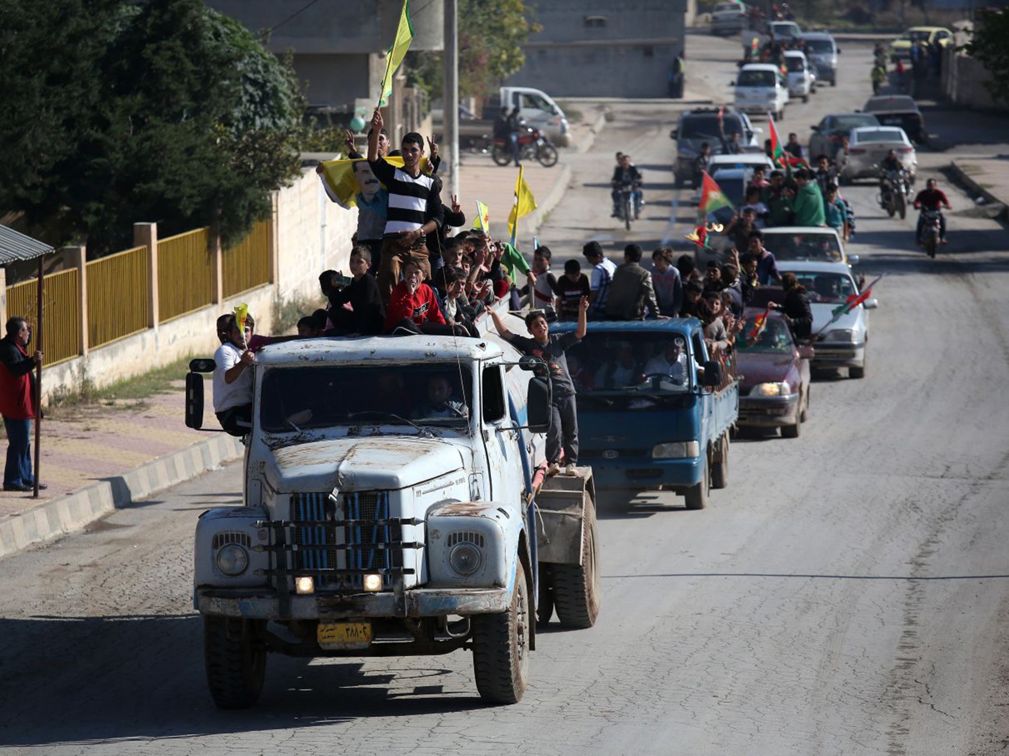 Yazidi refugees celebrating news of the liberation of their homeland of Sinjar from Isis extremists