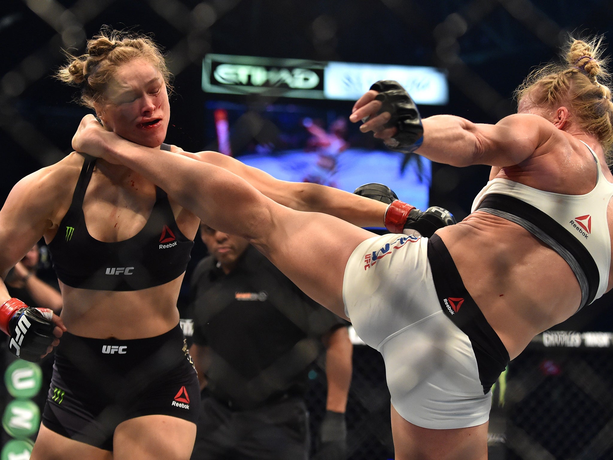 Holly Holm (right) delivers the stunning kick to floor Ronda Rousey