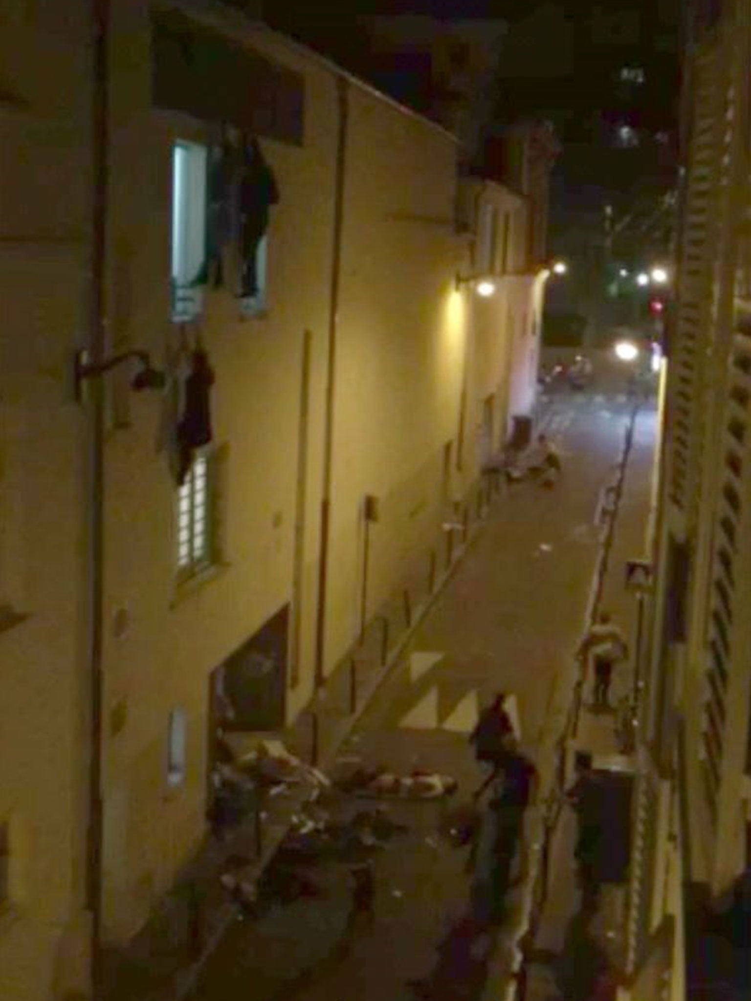 This still image made from a smartphone video by Le Monde’s French Journalist Daniel Psenny shows spectators fleeing the Bataclan concert hall