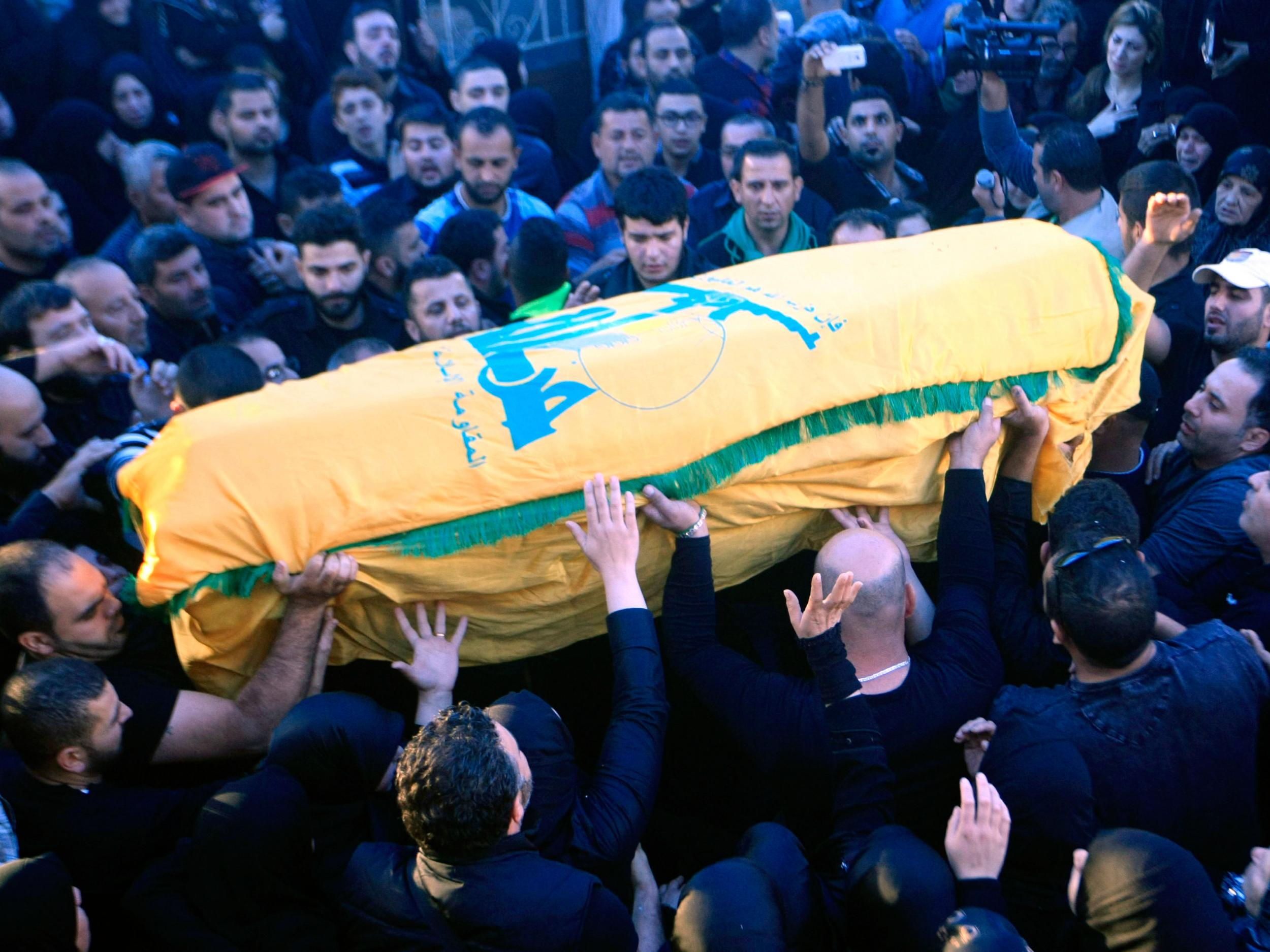 Relatives and friends carry the coffin of reported Hezbollah member Adel Termos, who was killed in Thursday's twin suicide bombings