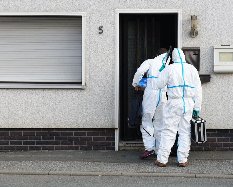 Investigators at the house in Wallenfels where the bodies of eight infants were found