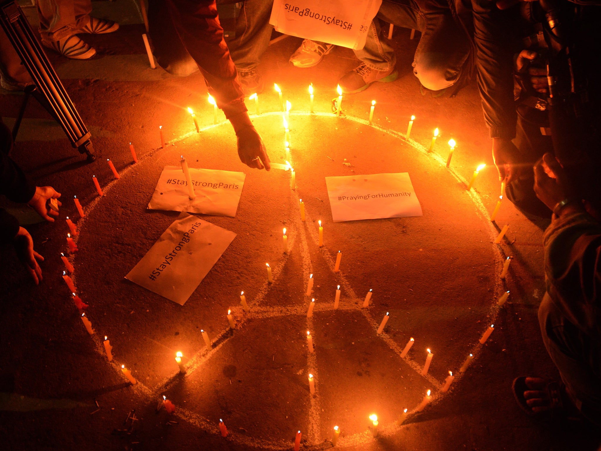 Nepalese people take part in a candle light vigil for the victims of the deadly attacks in Paris, in Kathmandu