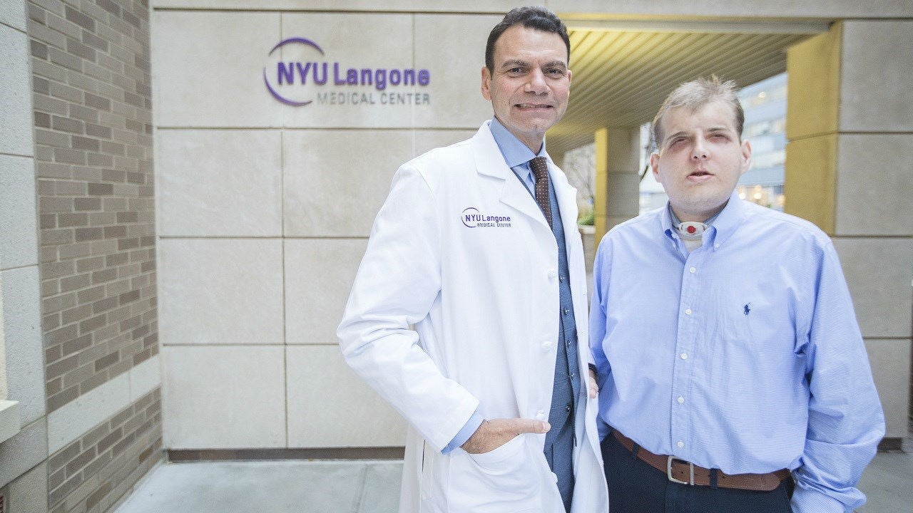 Dr Eduardo Rodriguez, left, pictured with his face transplant patient Patrick Hardison at NYU Langone