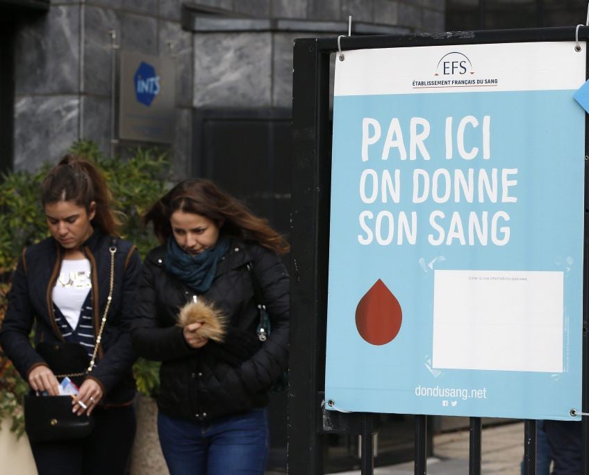 Two women leaving a blood donation centre in Paris in the wake of the attacks