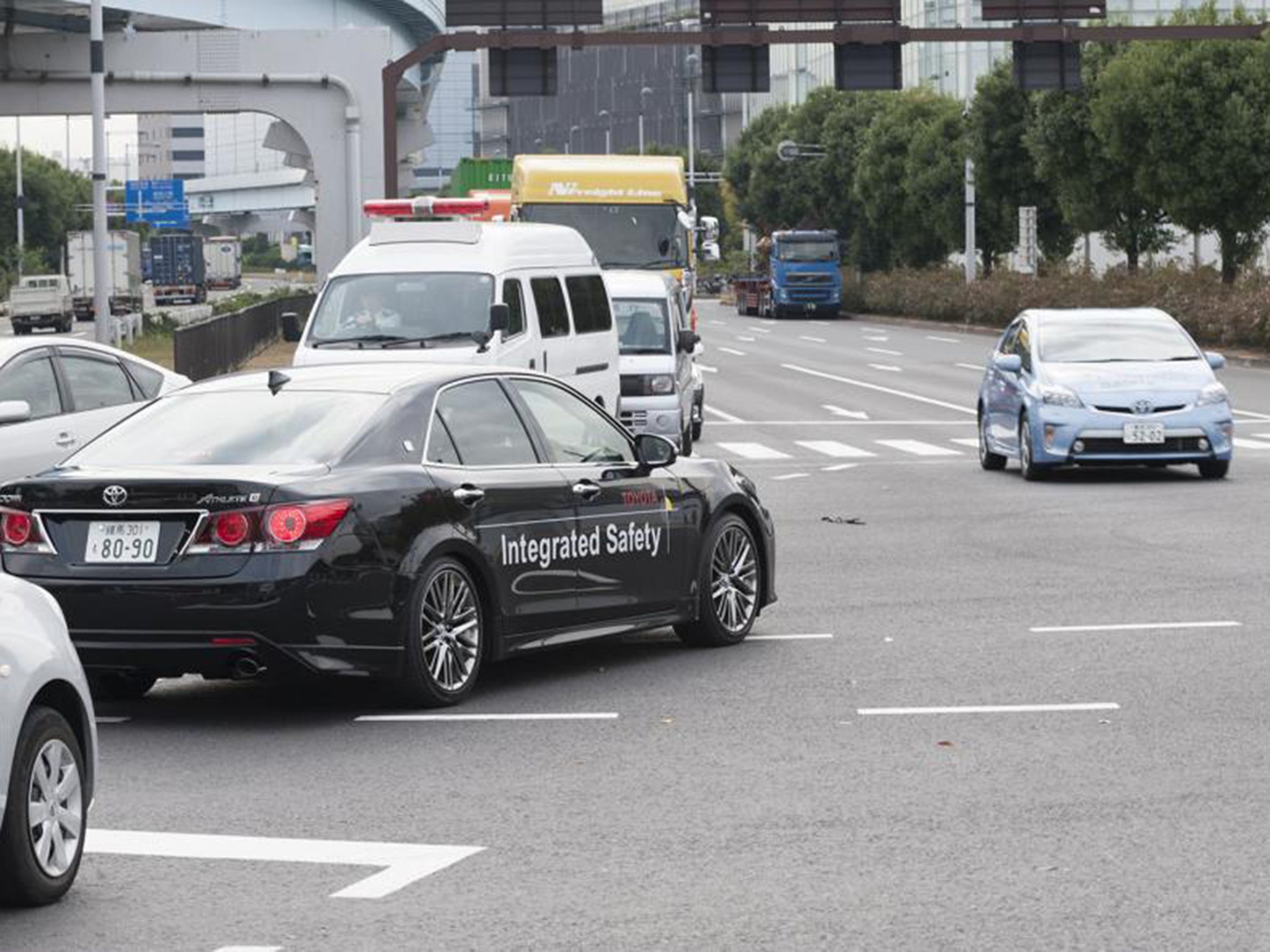 The car lets the driver know if they are not slowing as they approach a red light