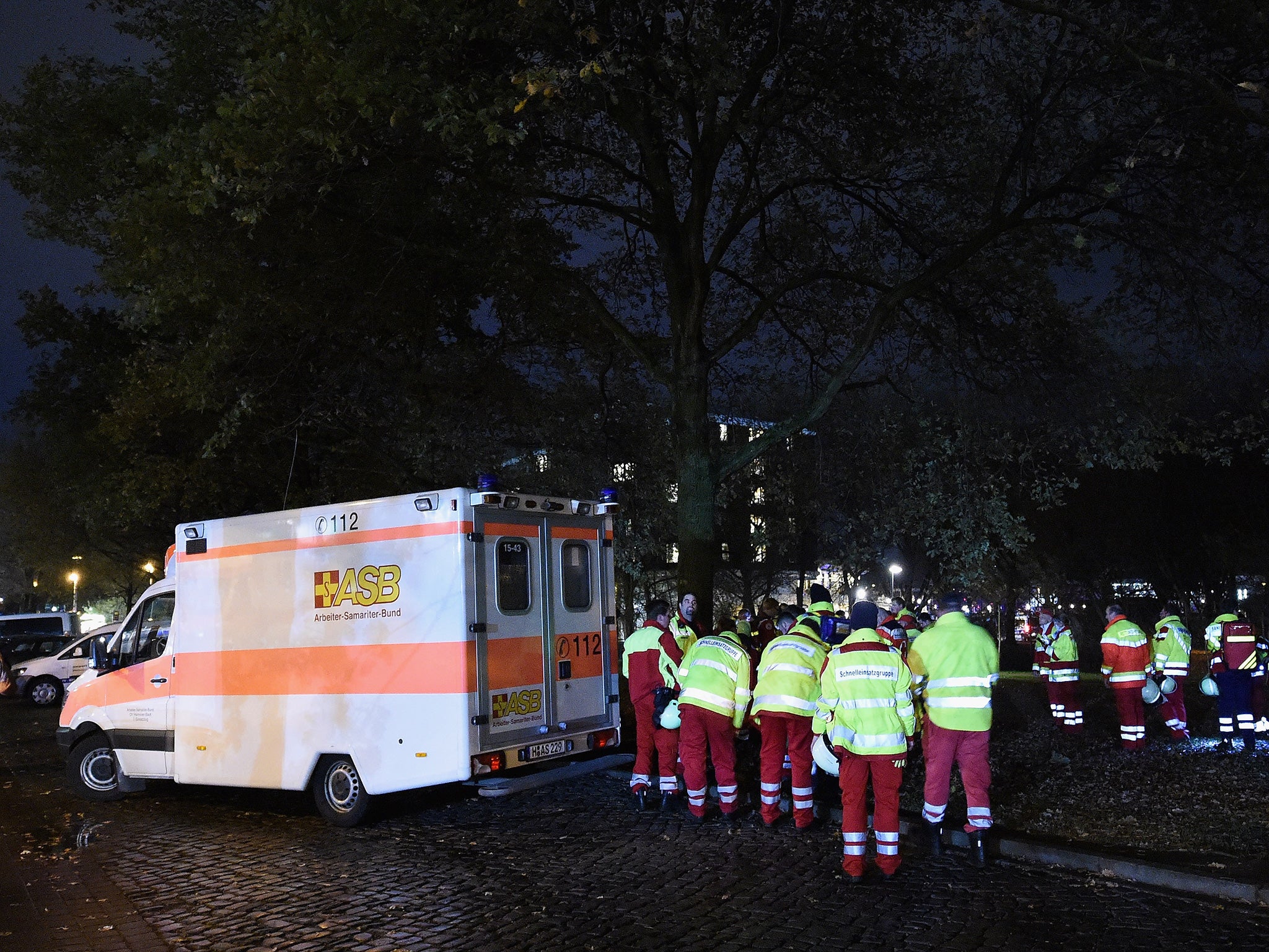 Emergancy service staff wait near an ambulance after the cancellation of the International friendly match between Germany and The Netherlands