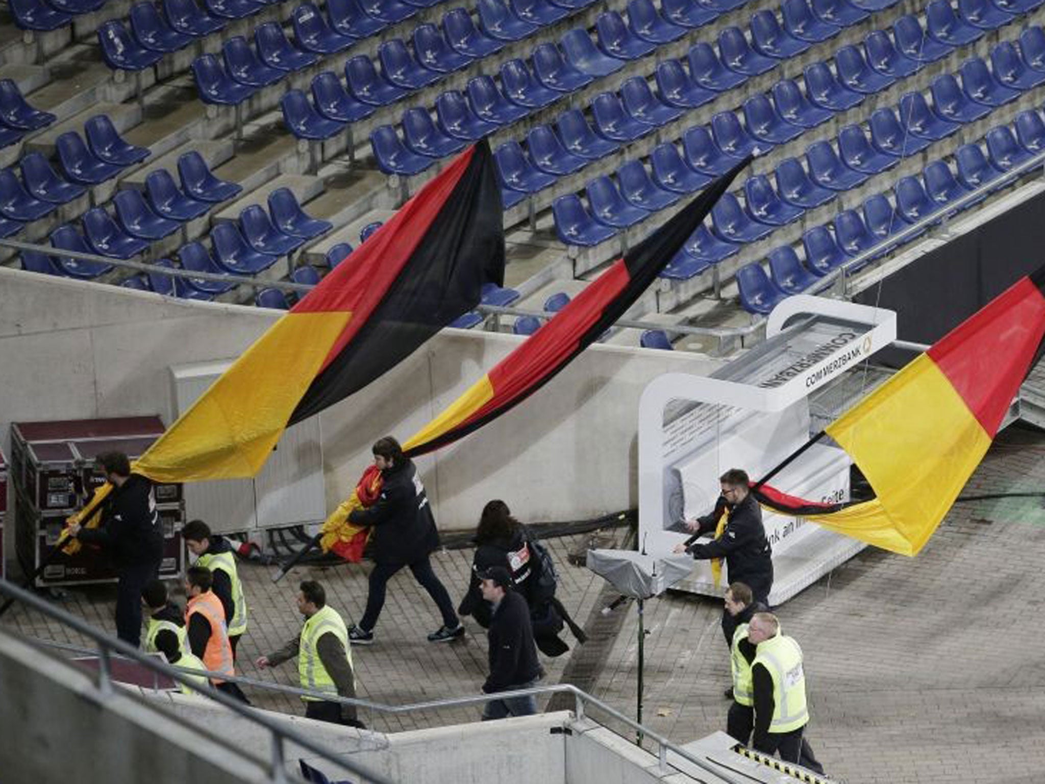 German flags are carried out of the Hannover stadium as the soccer friendly between Germany and the Netherlands was cancelled