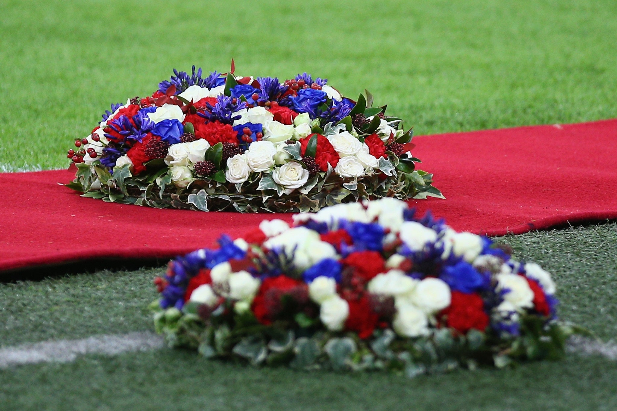 Floral wreaths are laid on the Wembley turf in honour of the Paris terror attack victims