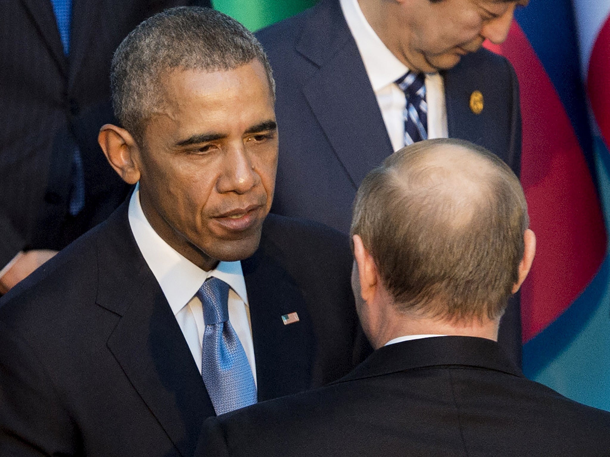 US President Barack Obama, left, talks with Russian President Vladimir Putin as they arrive for the official family photo during the G20 summit in Antalya, Turkey