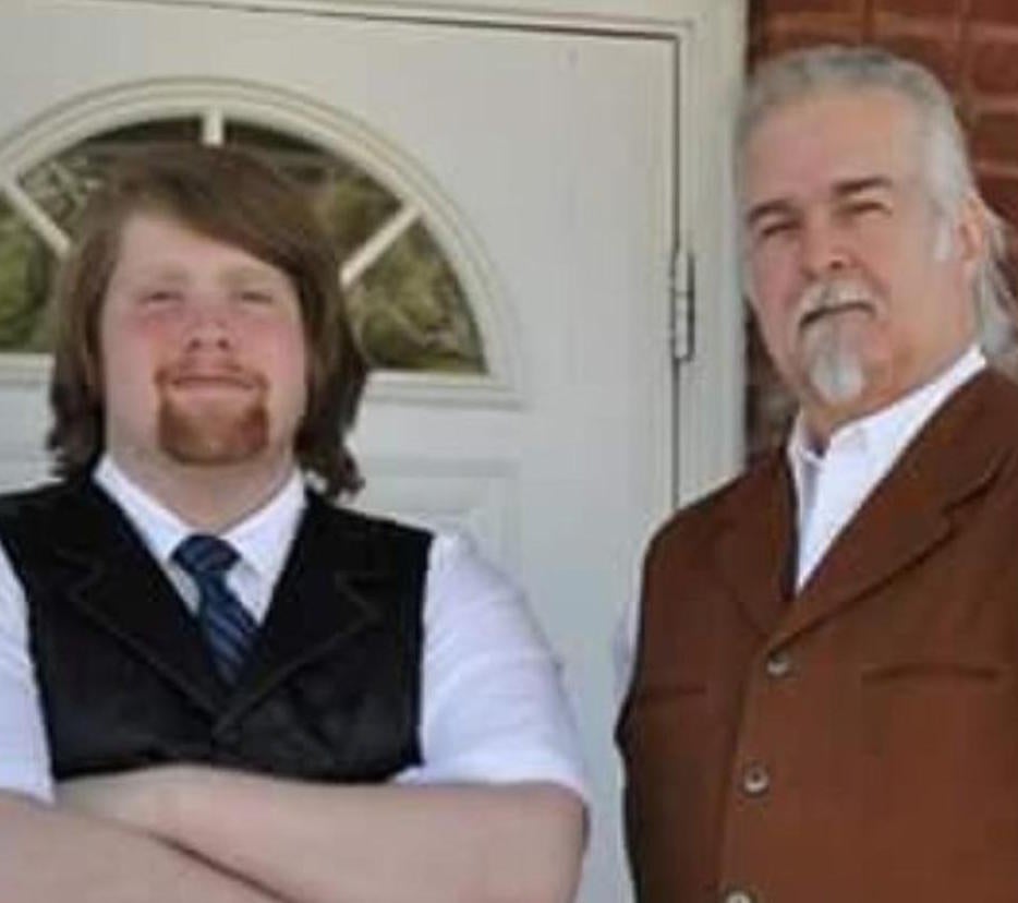 Thomas Riggs (l) stands with his father Anthony Riggs (r)