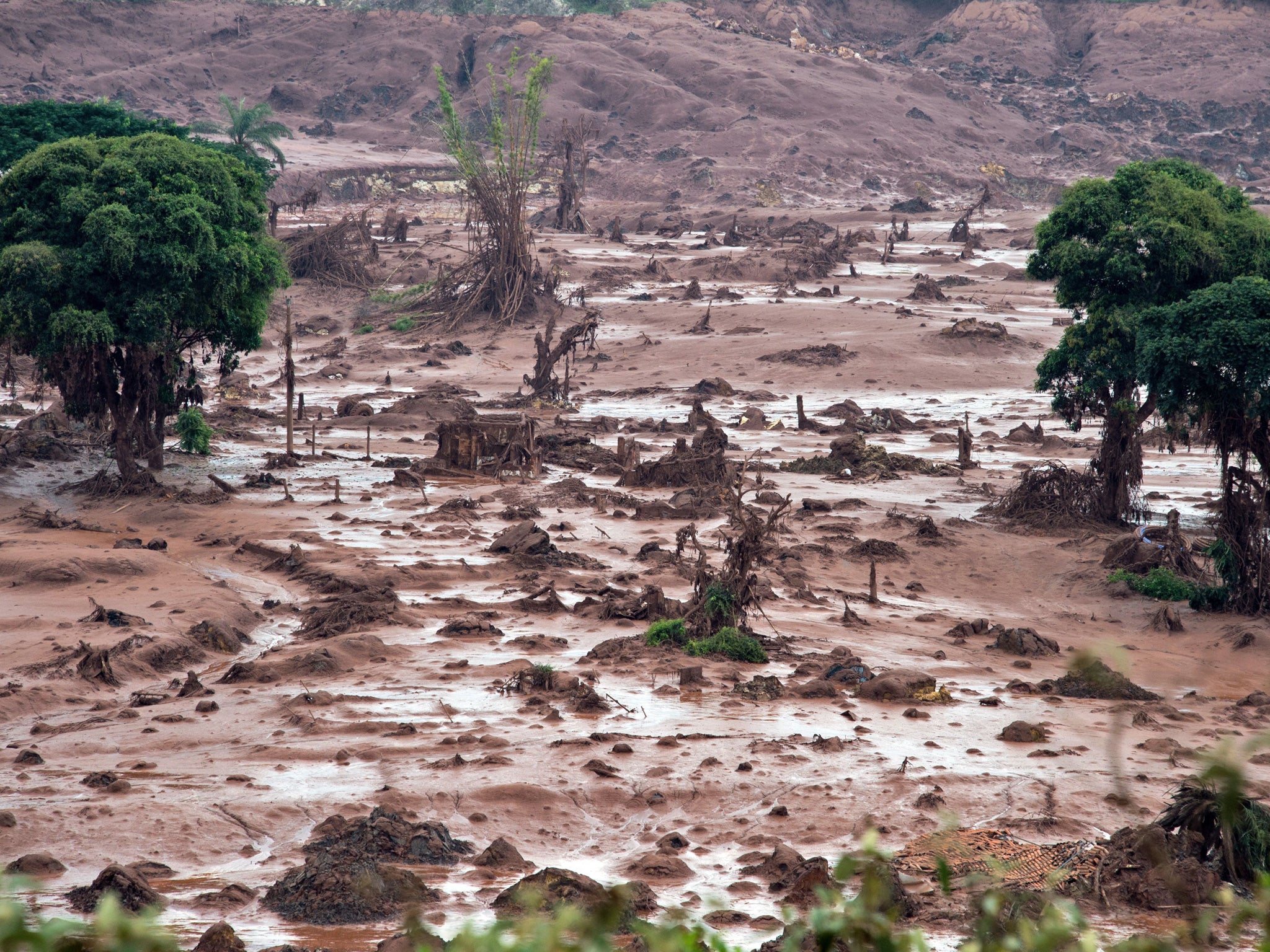 Aerial view after a dam burst in the village of Bento Rodrigues, in Mariana, Minas Gerais state, Brazil on November 6, 2015. The mining company Samarco, which operates the site, is jointly owned by two mining giants, Vale of Brazil and BHP Billiton of Australia.