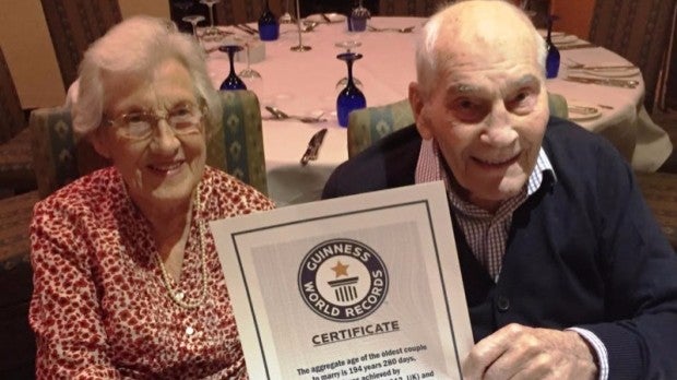 The newlyweds proudly show-off their Guinness World Records certificate