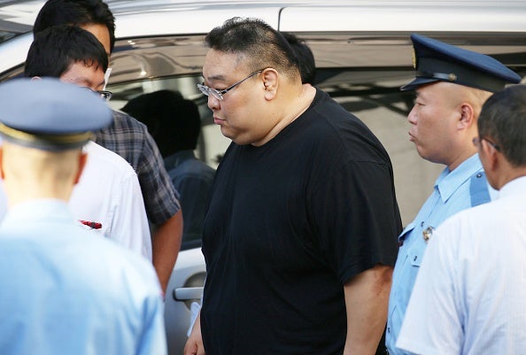 Yamamura, centre, at a police station in Tokyo after being arrested for the alleged abuse against the man hired as a driver