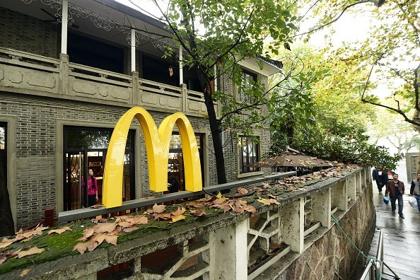 Locals walk past the controversial restaurant near the famed West Lake tourist spot in east China's Zhejiang province