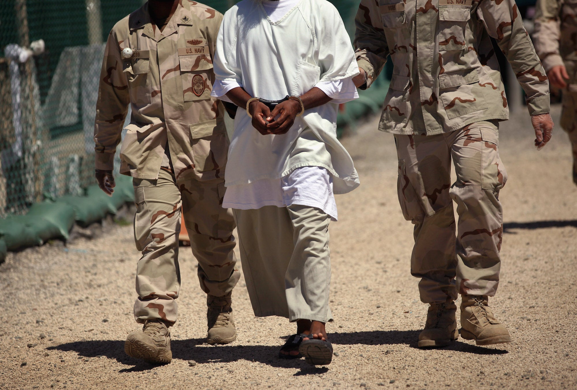 US Navy guards escort a detainee at Guantanamo Bay. Getty