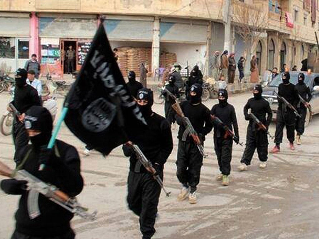 Isis fighters marching in Raqqa, Syria