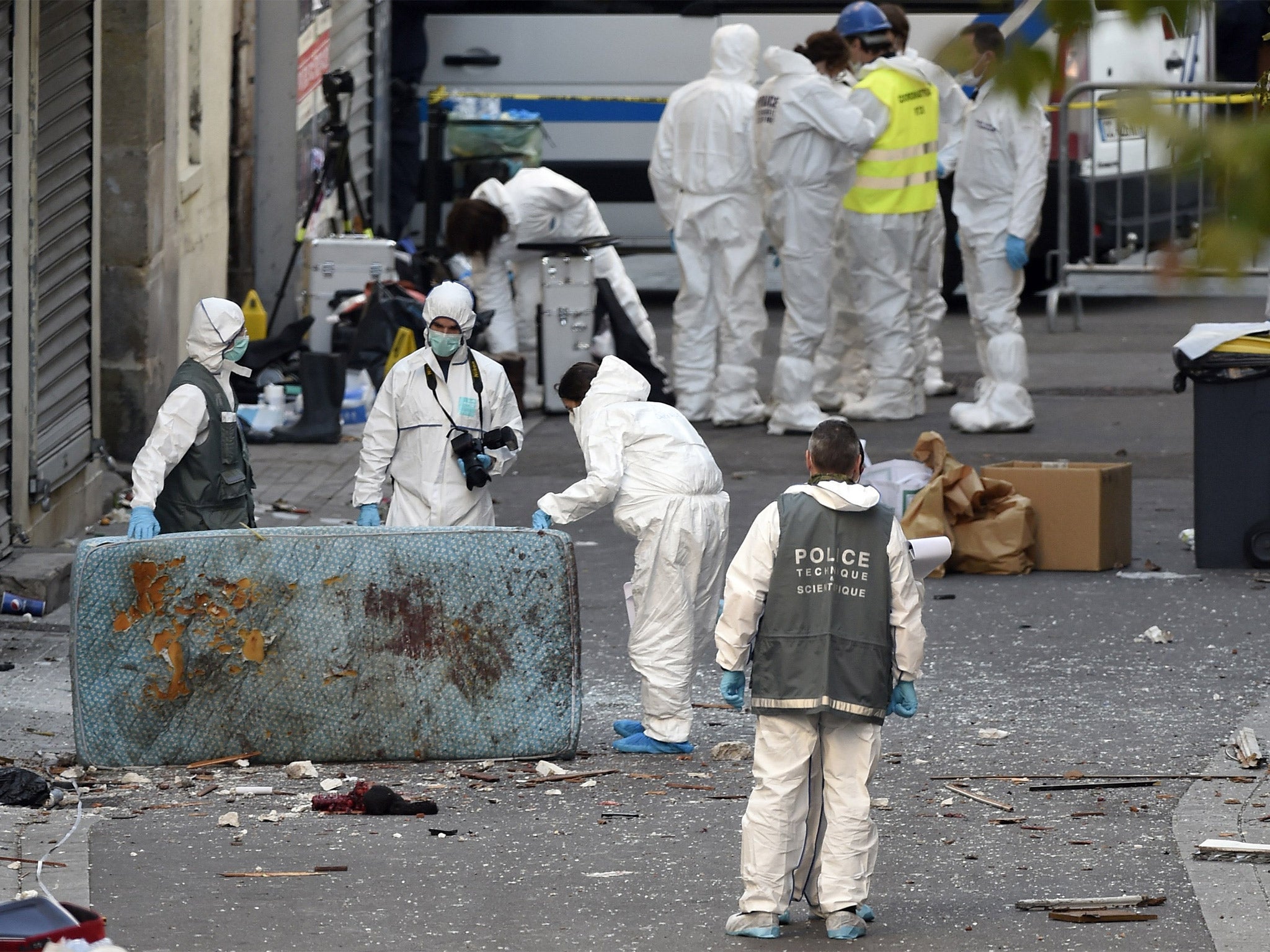 Forensic officers search for evidence following the raid on a building in Saint-Denis