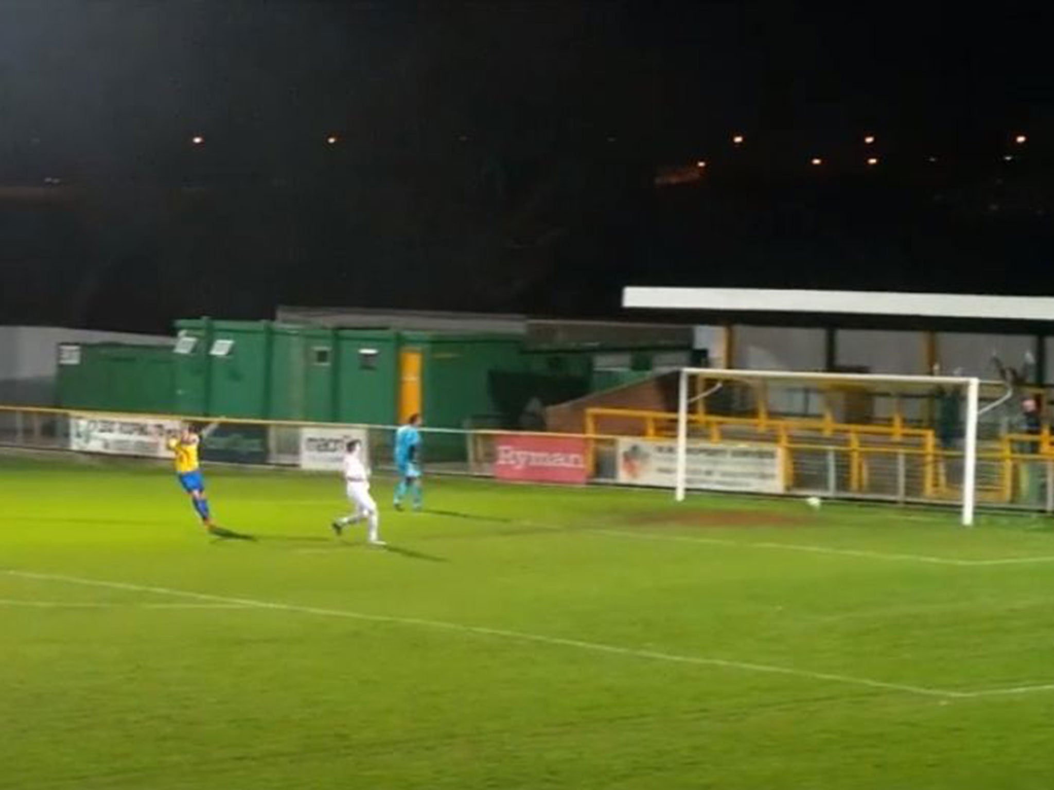 Romford players celebrate as Madden is left to fetch the ball out of his own net