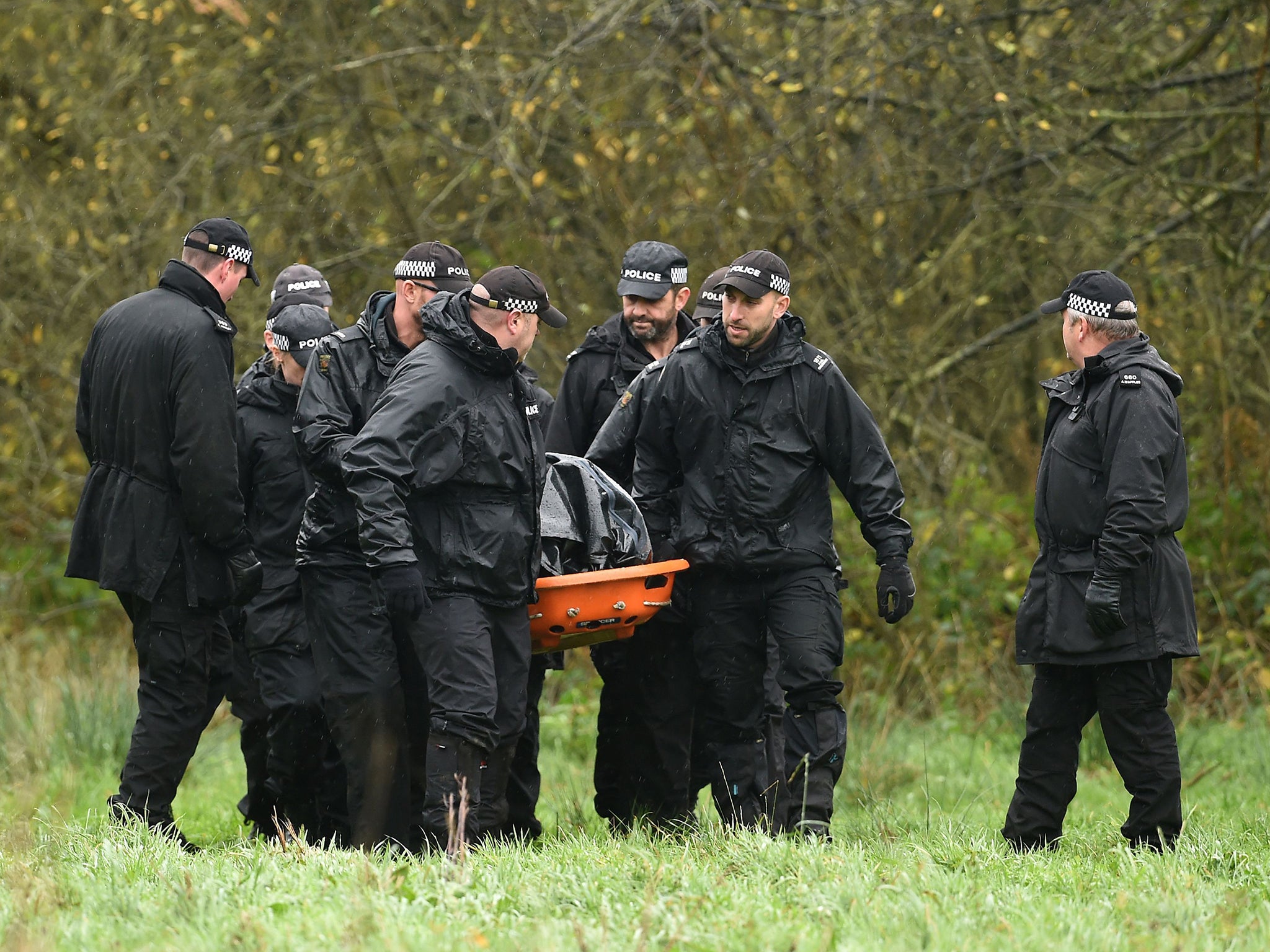 Police remove a body on a stretcher from undergrowth around a lake in Ibstock, Leicestershire, where they have been searching for missing Kayleigh Haywood