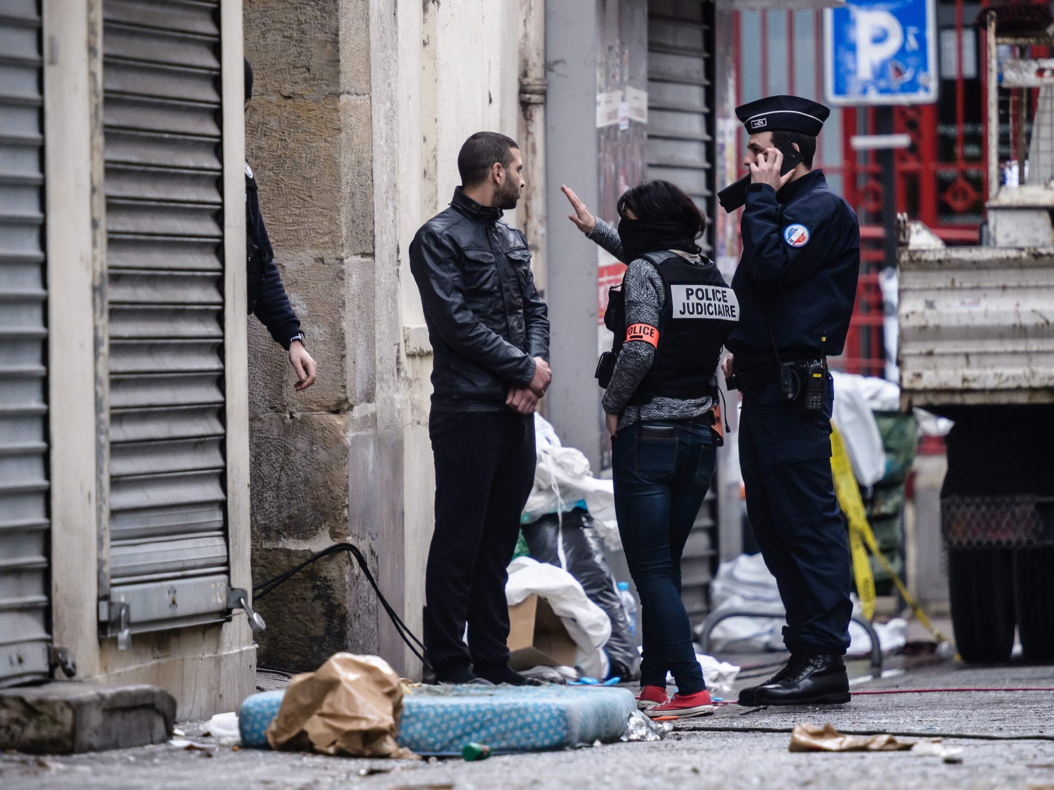 French police outside the Rue du Corbillon building in Saint-Denis