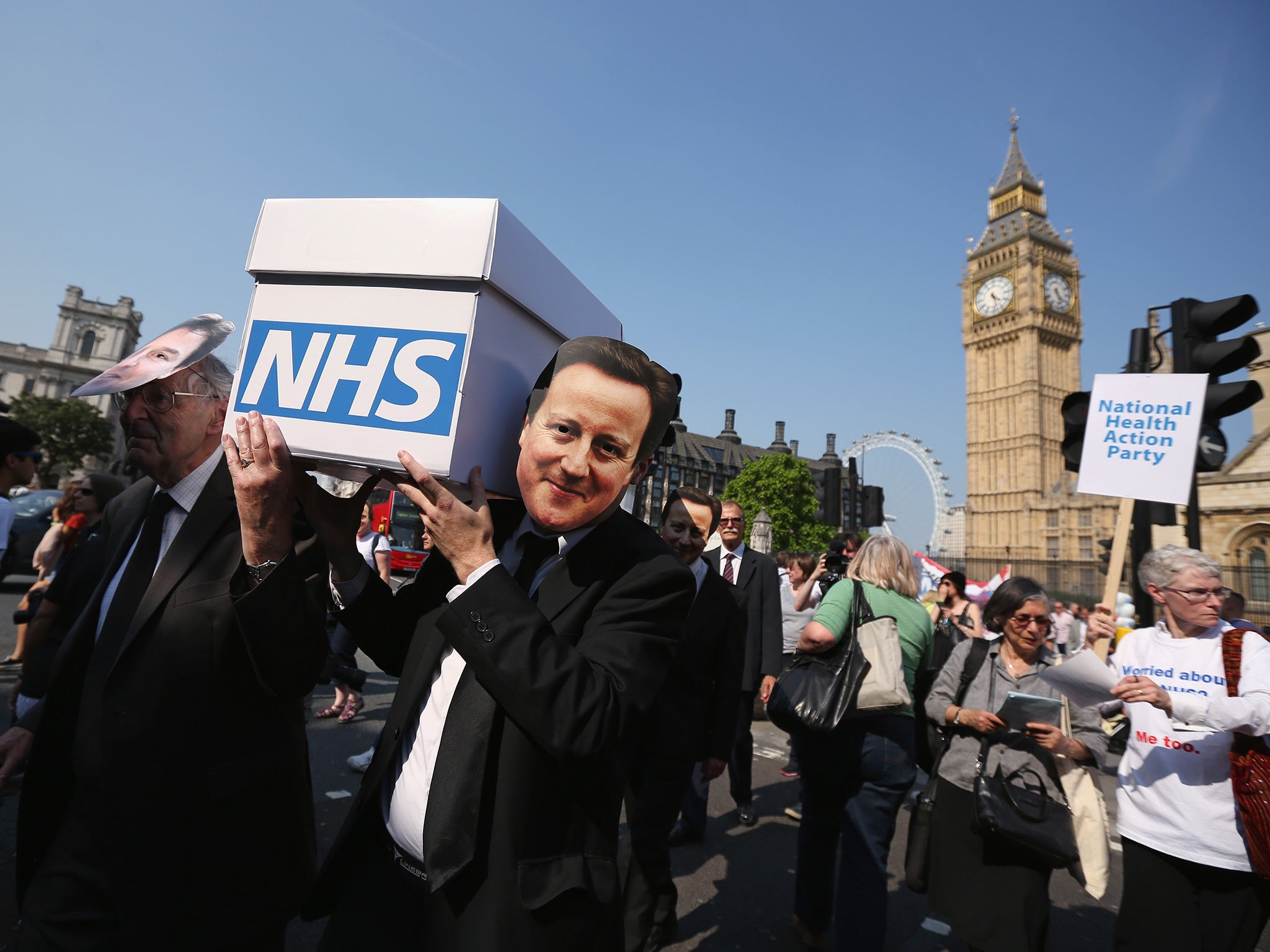 Protesters from the 'National Health Action Party', critical of the Government's changes to the Health Service, lead a mock funeral procession for the NHS along Whitehall