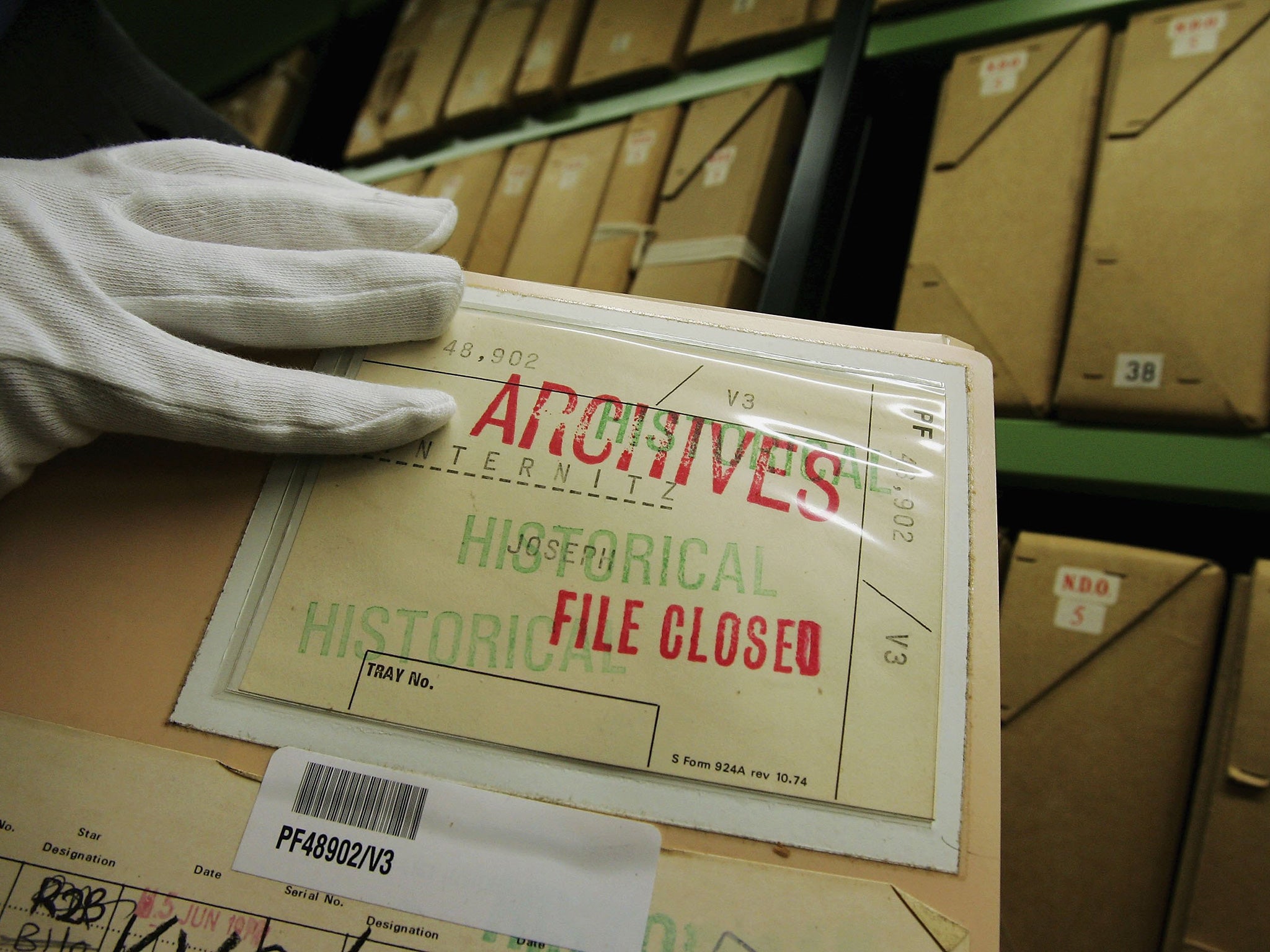 A member of staff removes a file from a depository at The National Archives. Many documents from the National Archives are available thanks to the Freedom of Information Act