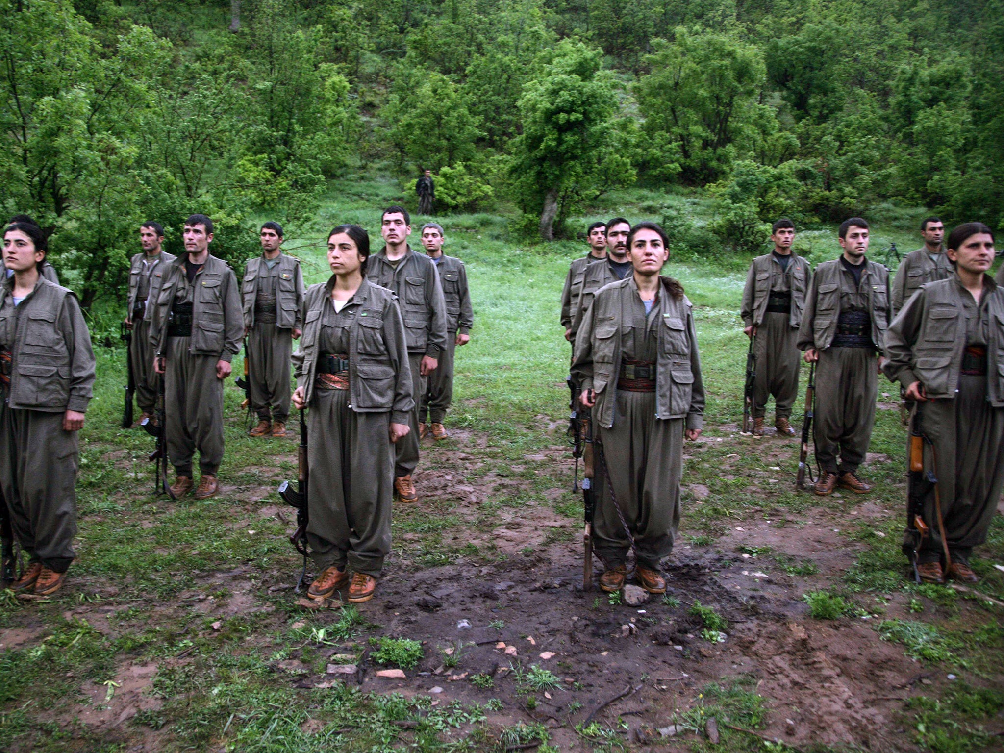 PKK soldiers stand to attention after arriving in the northern Iraqi city of Dohuk