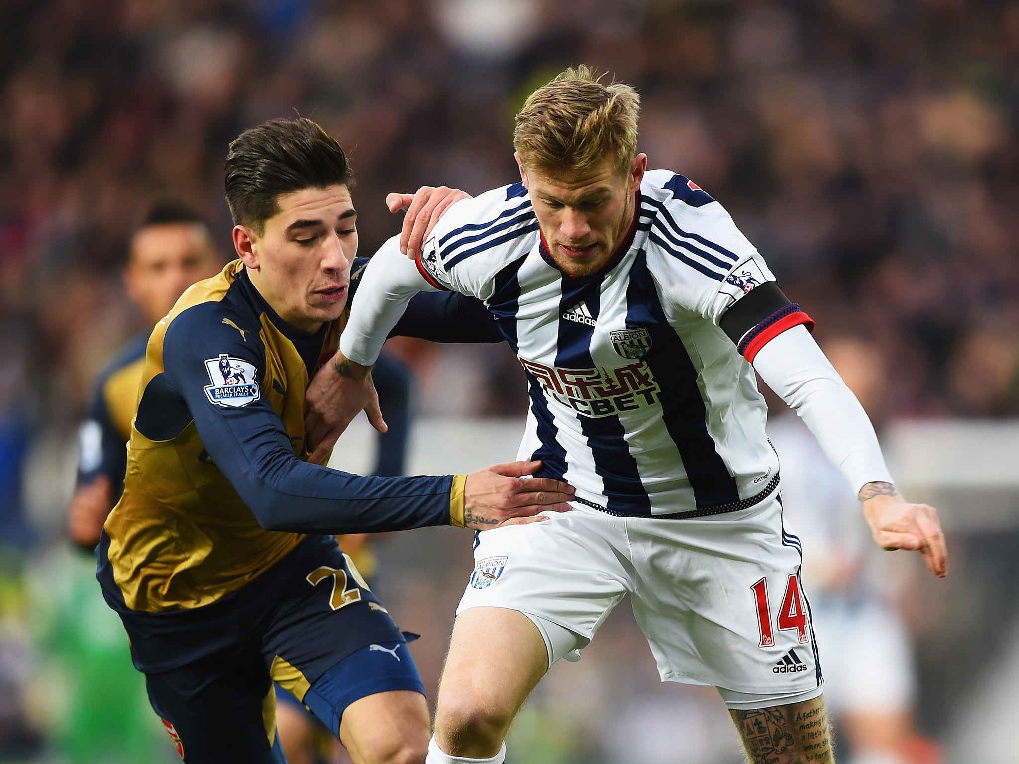 Hector Bellerin and Chris Brunt challenge for the ball