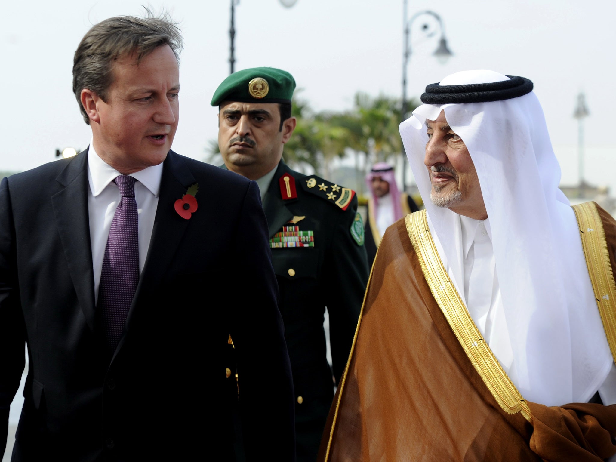 Saudi Emir of Mecca, Prince Khalid bin Faisal bin Abdulaziz (R) welcomes British Prime Minister David Cameron to Saudi Arabia in 2012