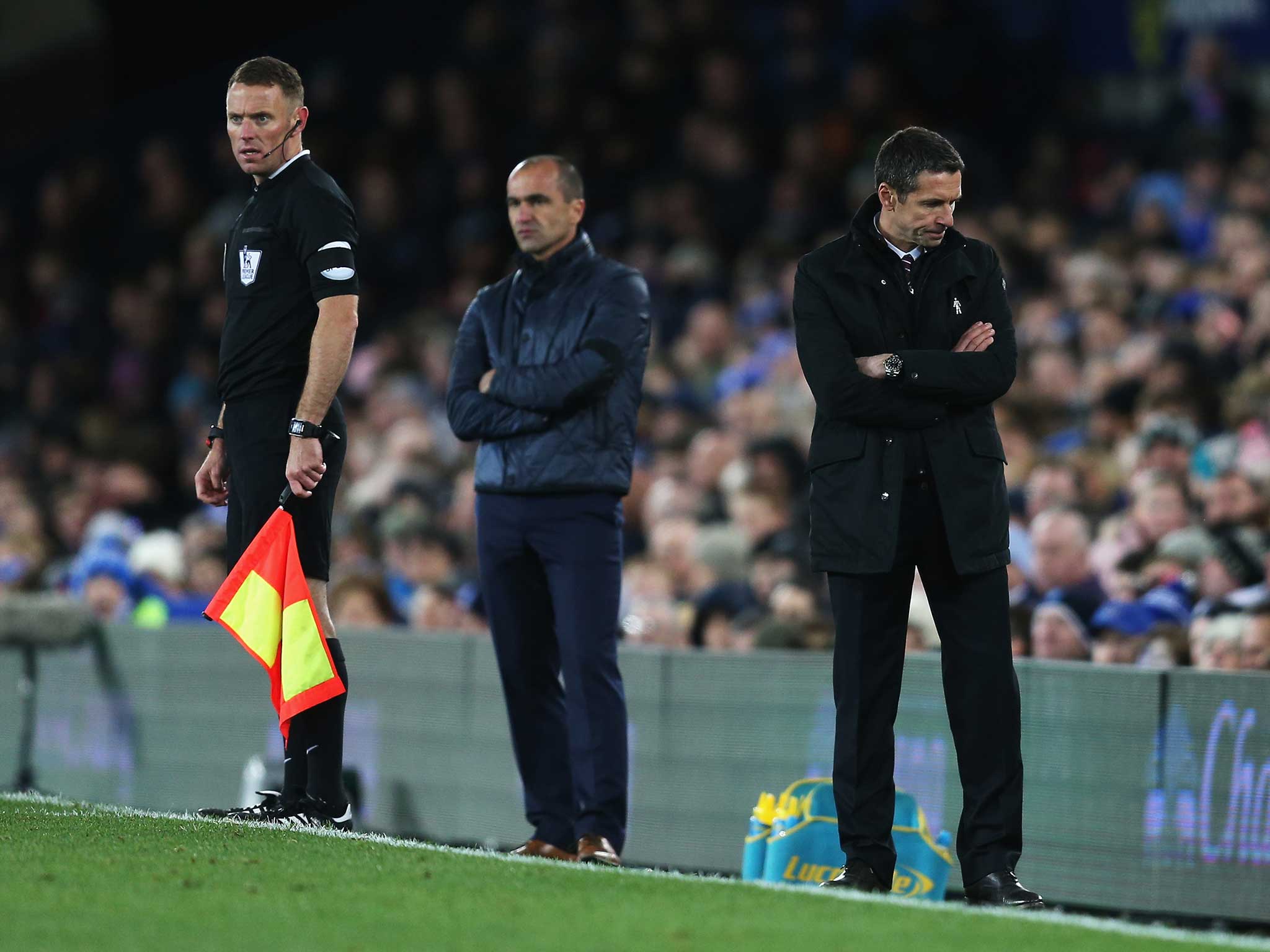 Remi Garde (R) can't look on during the match against Everton