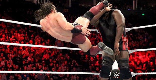 Neville kicks Mark Henry in the head