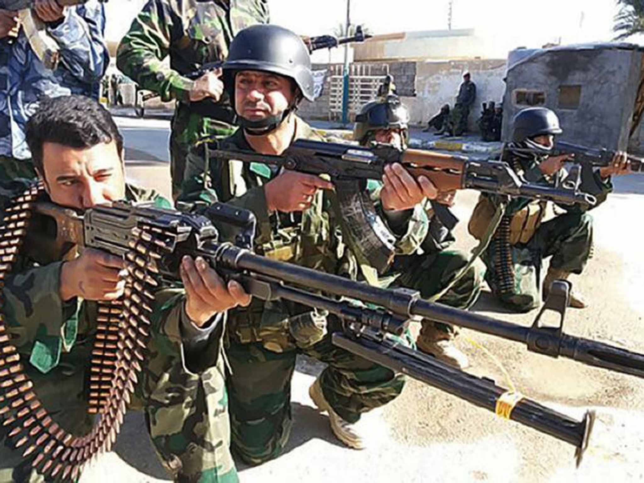 Our enemy’s enemy: Iraqi troops strike valiant poses outside Ramadi in 2014, prior to an operation to drive out Isis forces holding the city