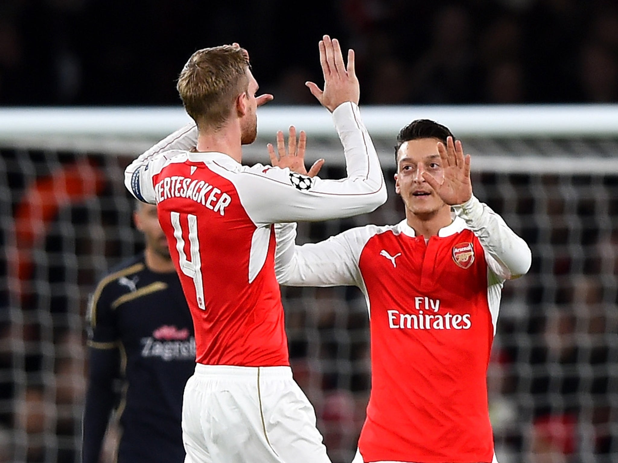 Per Mertesacker congratultes Mesut Ozil on scoring Arsenal's opener