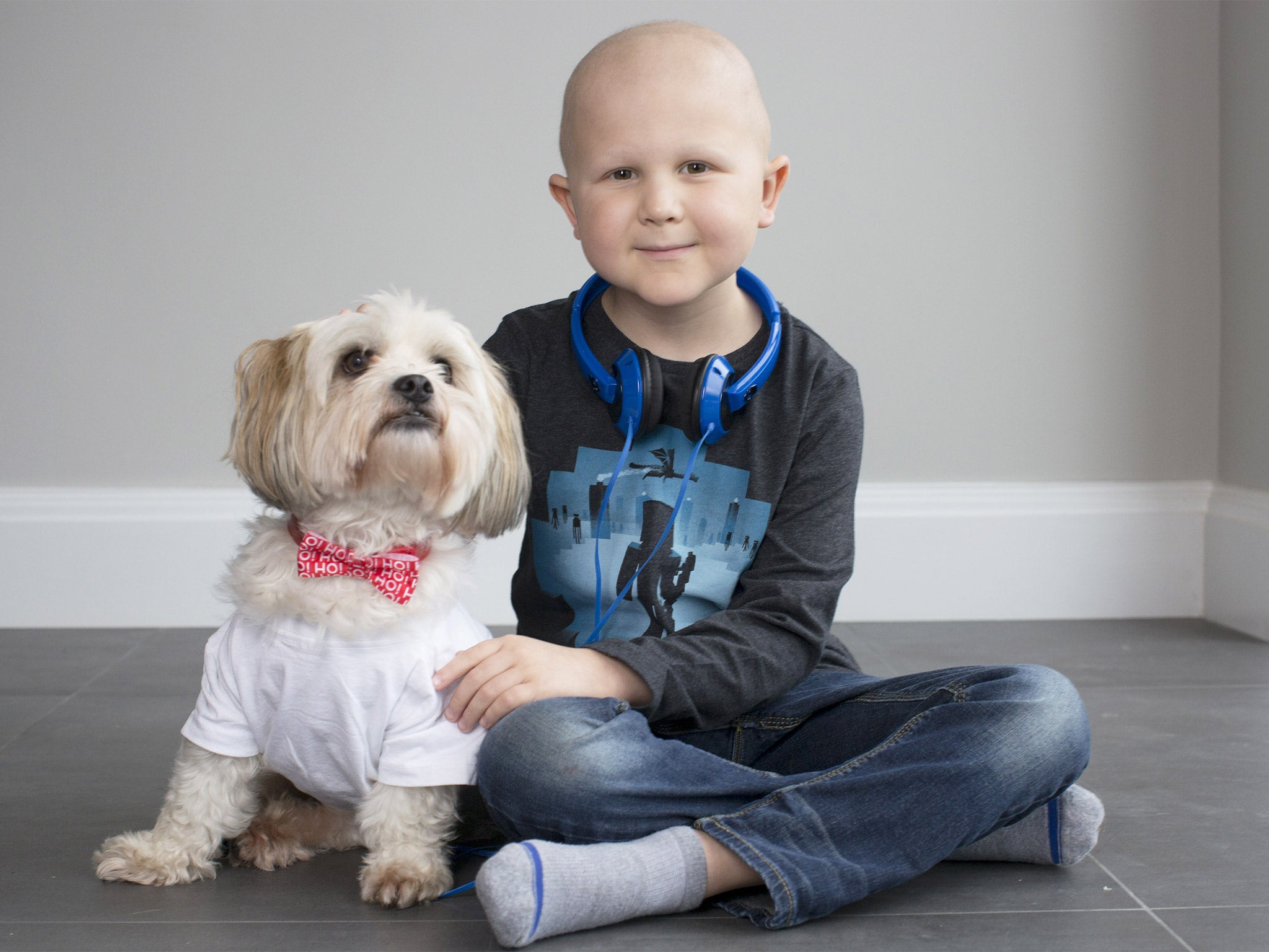 Rowan, a leukaemia outpatient at GOSH, with his grandmother’s dog, Woody