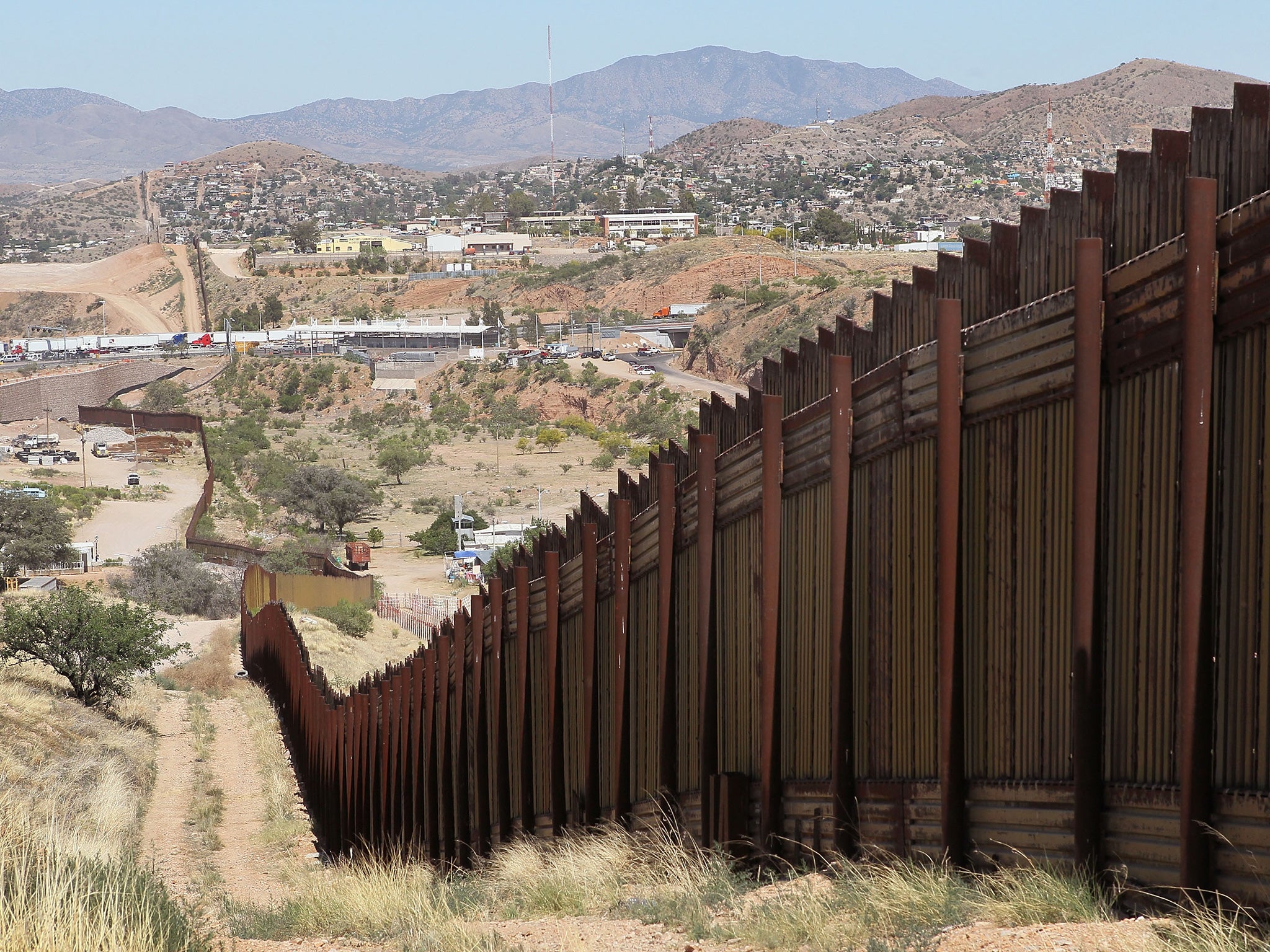 A fence separates the cities of Nogales, Arizona (left) and Nogales, Mexico, a frequent crossing point for people entering the United States illegally