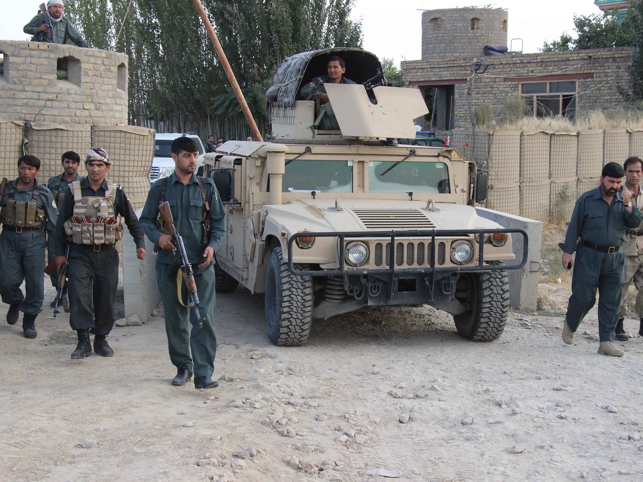 Afghan security personnel on patrol in Kunduz after Taliban insurgents briefly seized the city in September