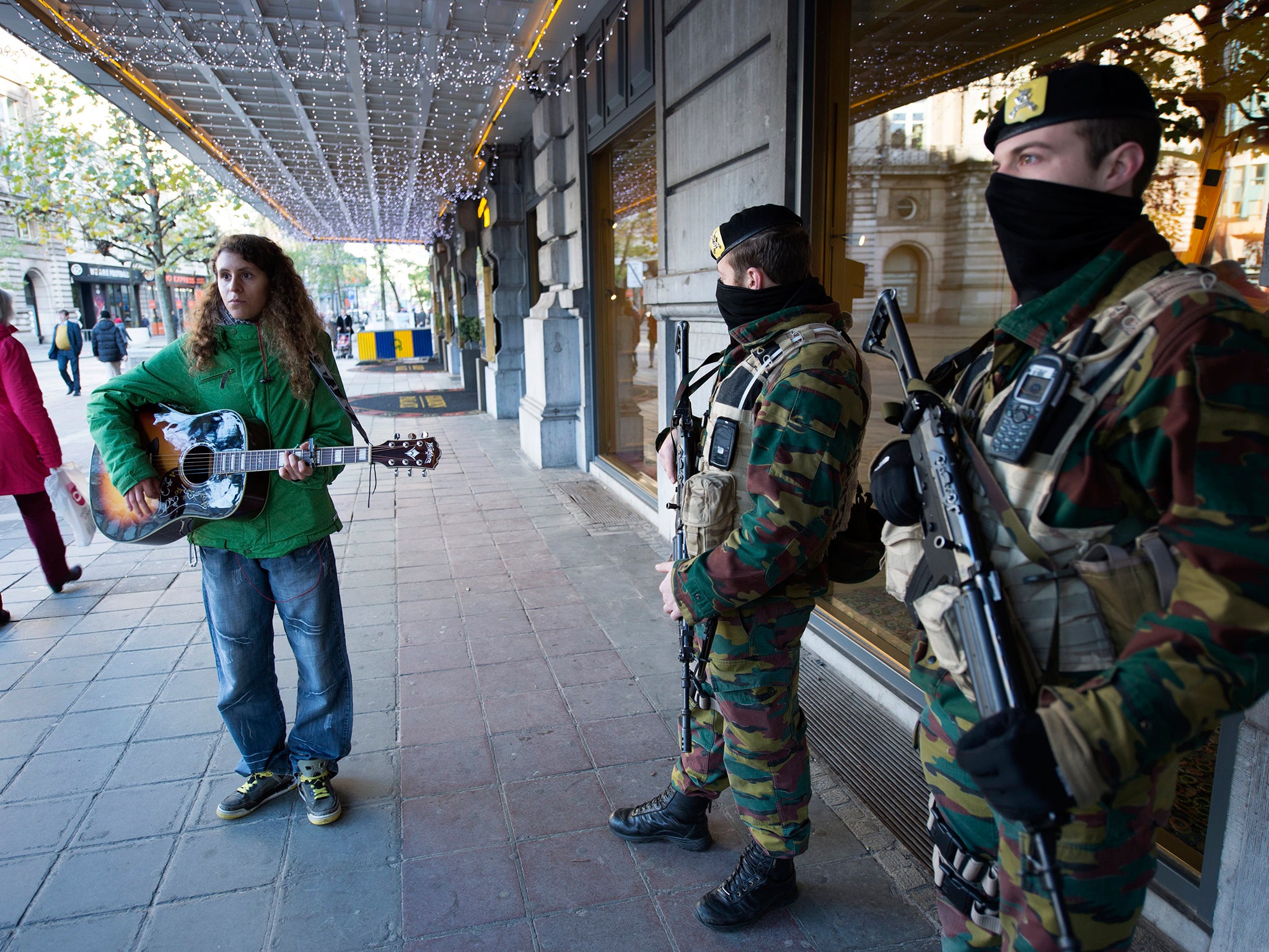 Although the threat level has fallen, soldiers will remain on guard at key points across Brussels