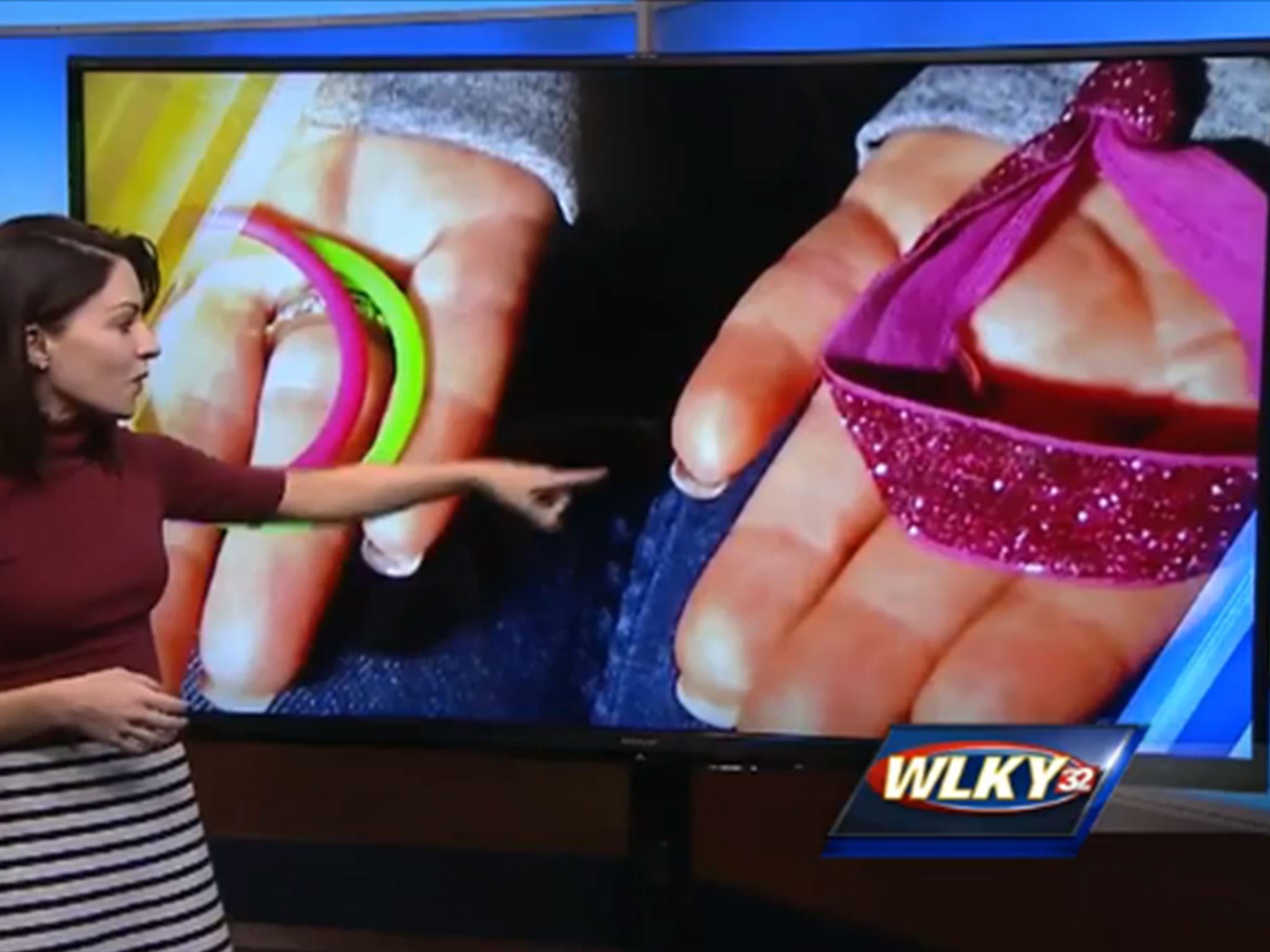 &#13;
A news reporter gestures towards the type of hair band which caused Ms Kopp's problem&#13;