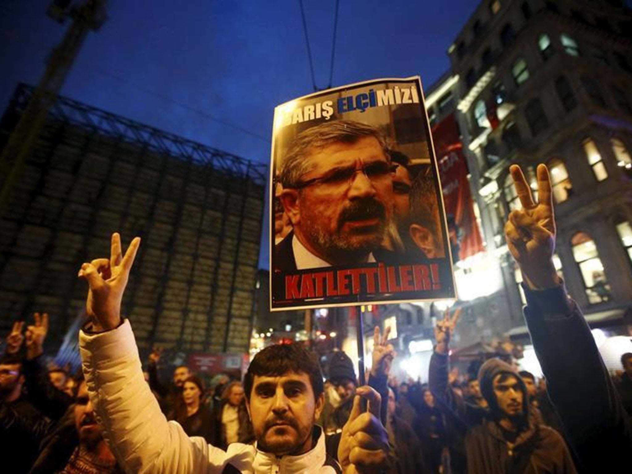 A demonstrator holds picture of Tahir Elci during a protest in Istanbul