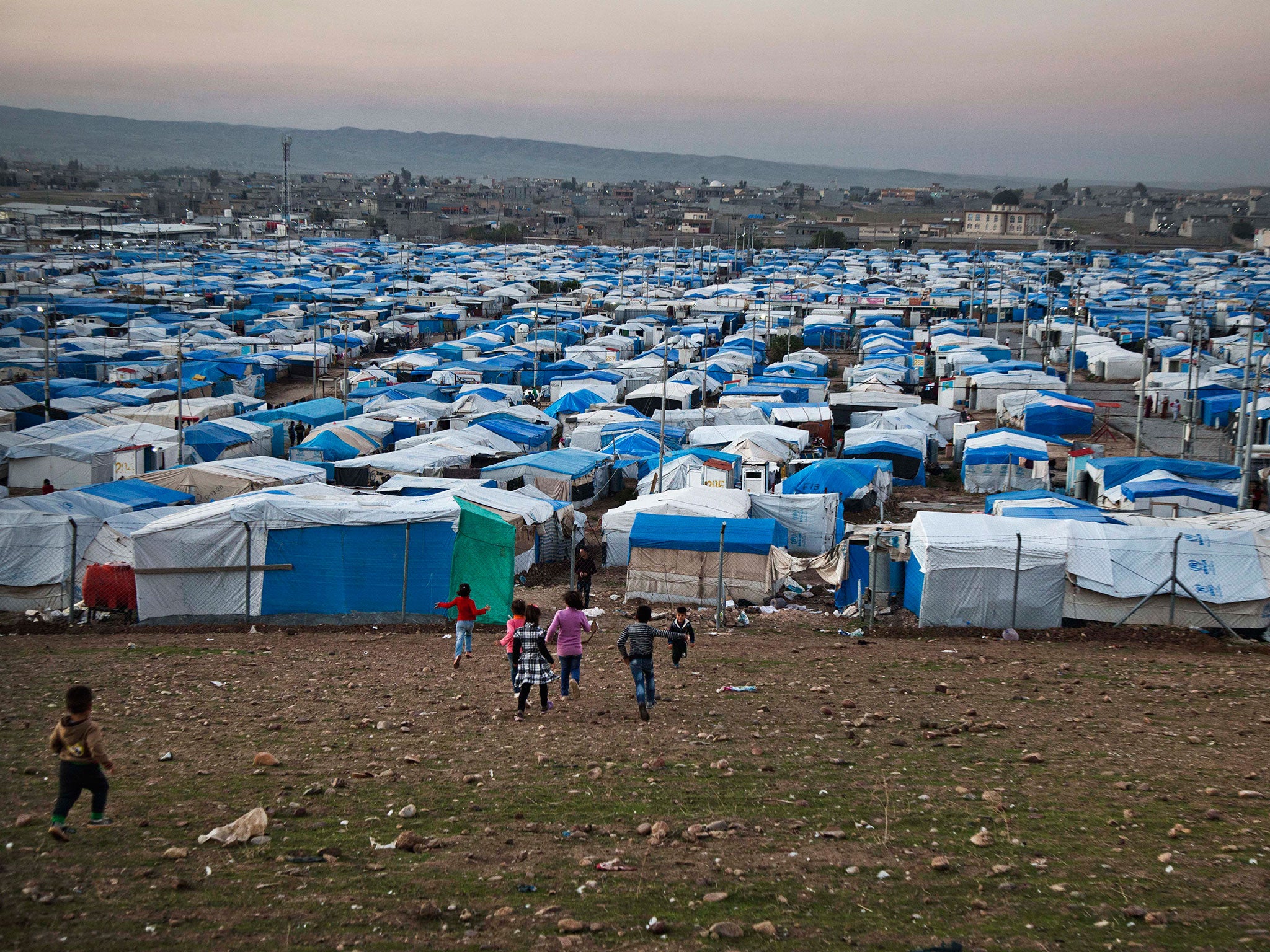 Syrian refugee children run at a temporary refugee camp in Irbil, northern Iraq.