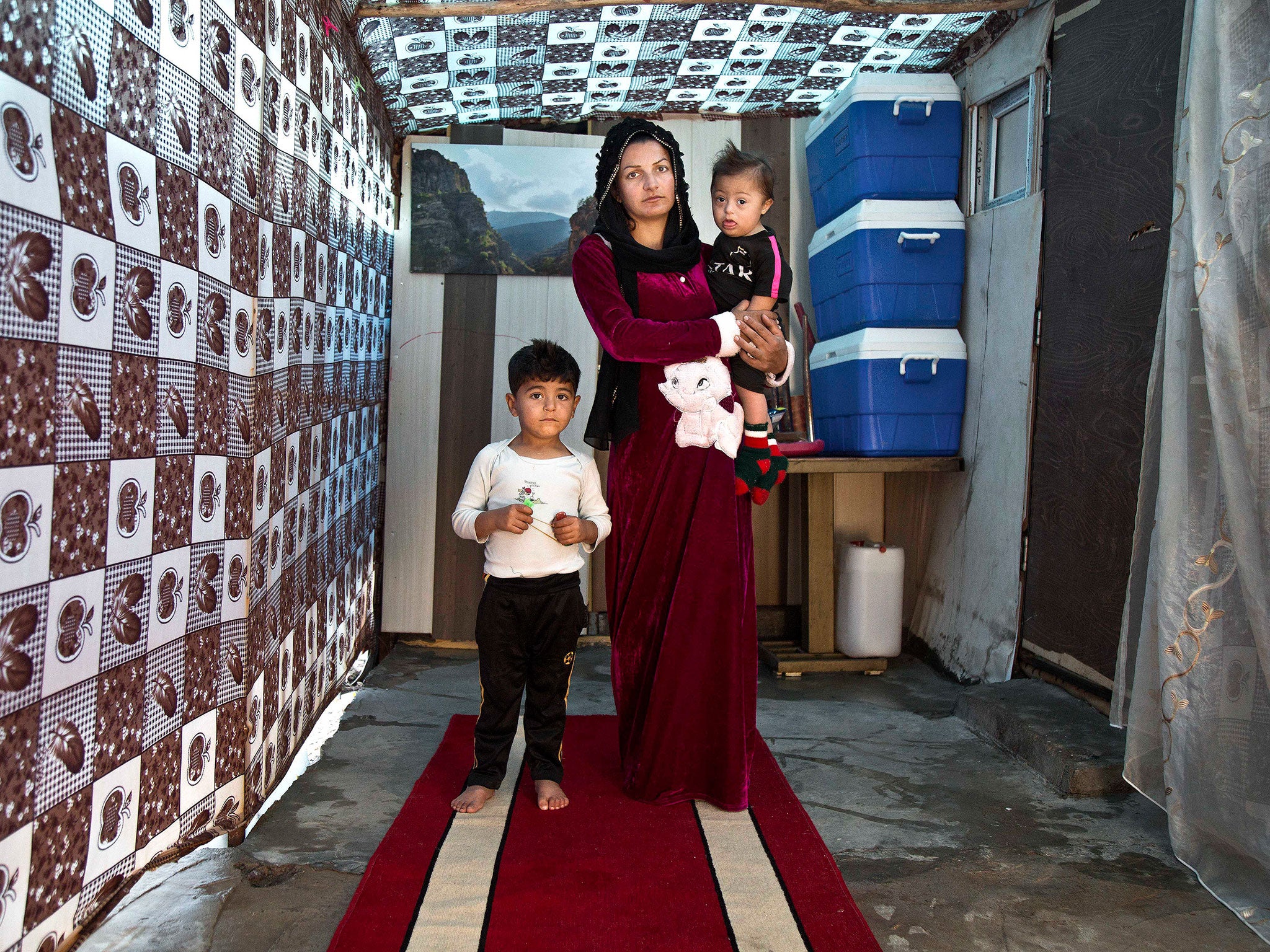 24-year-old Syrian refugee Aziza Suleyman poses for a photograph with her children