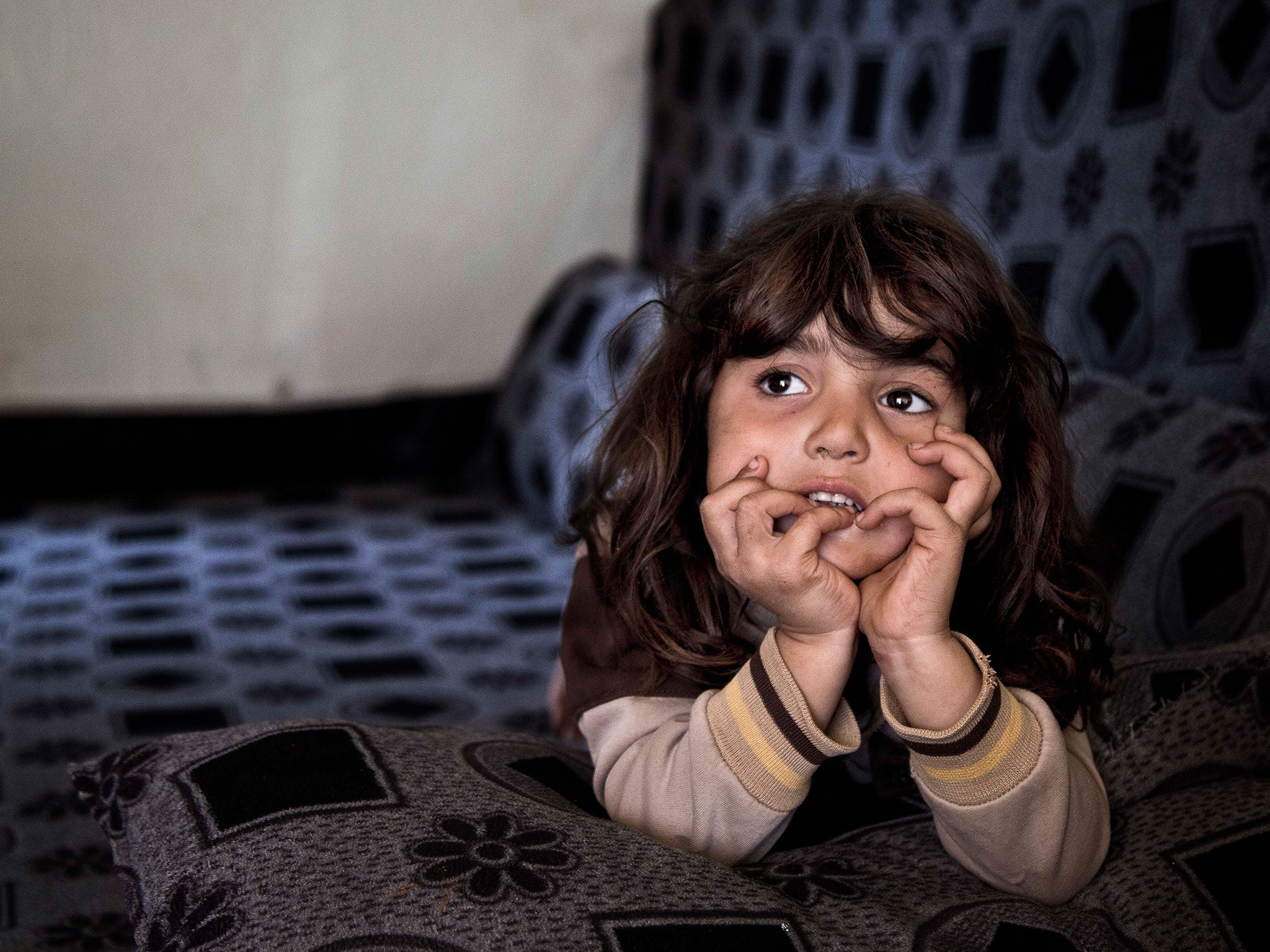 Syrian refugee Simav Nuh, rests inside an informal tented settlement in Irbil, northern Iraq