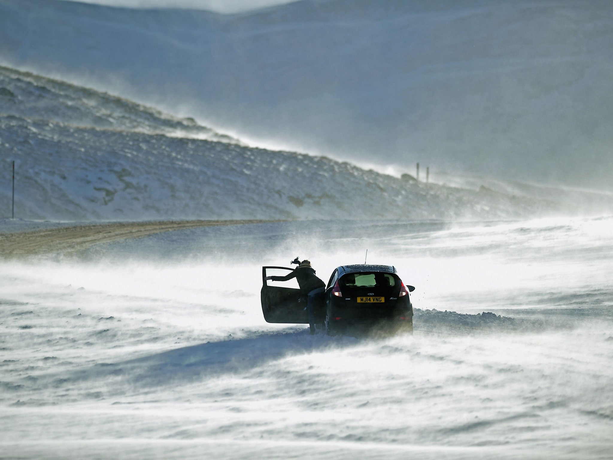 People push a car stuck on the A93 Braemar to Glenshee road, one of the stretches of road that has been found to have no mobile phone coverage