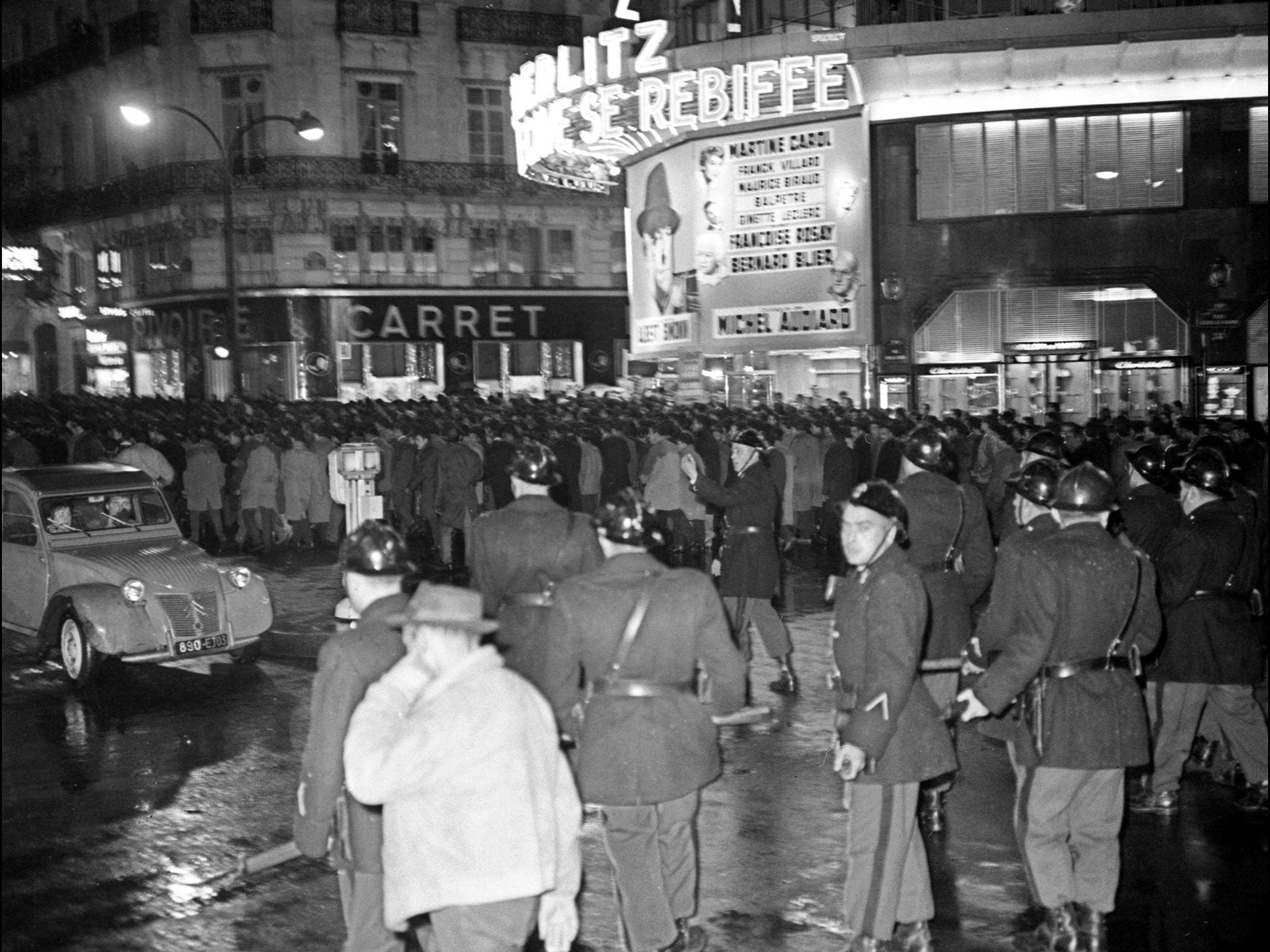 French police observe the march of between 20,000 and 30,000 pro-FLN Algerians in Paris in 1961. They would later massacre hundreds of the protesters