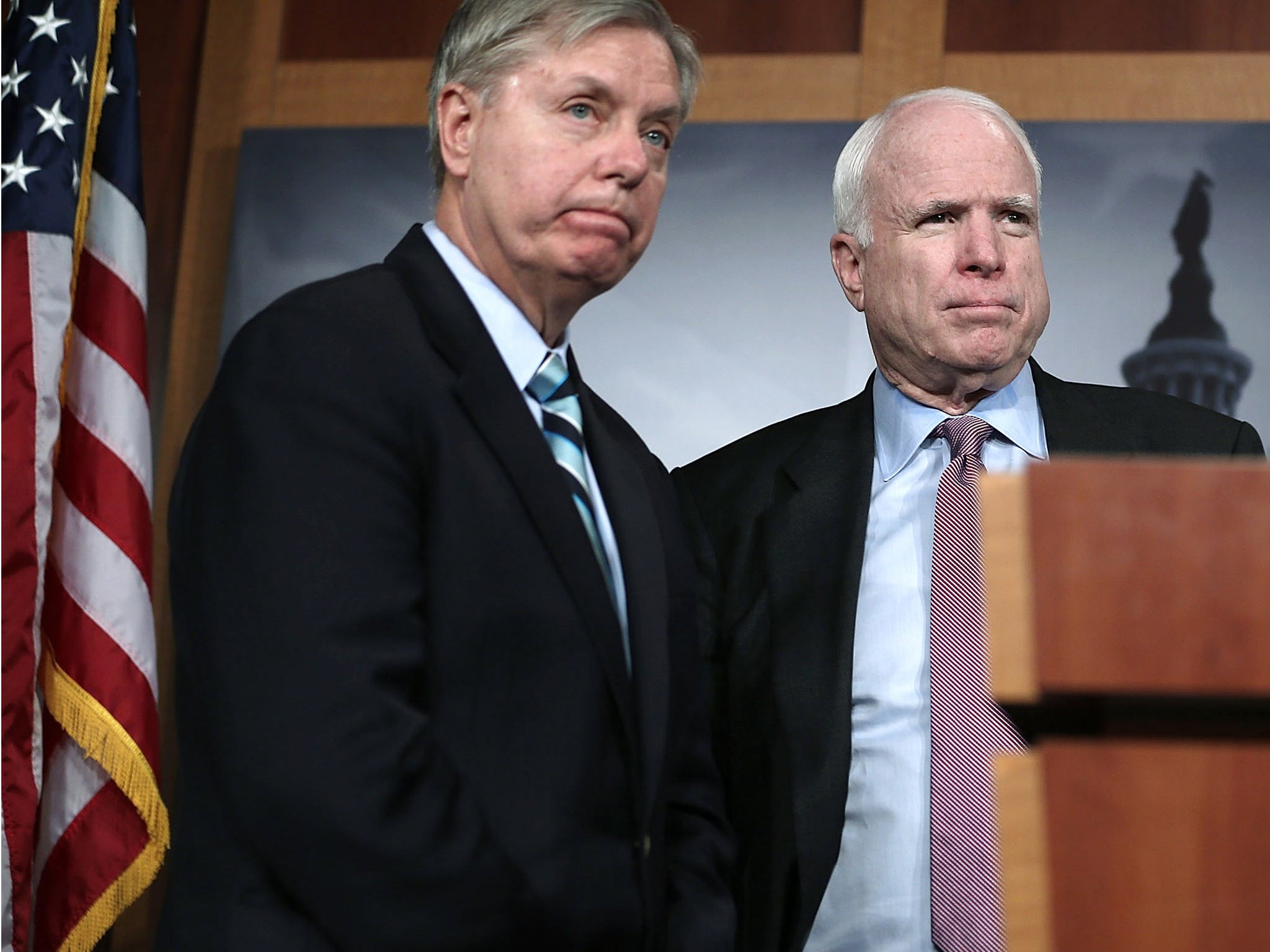 US Senator John McCain (R), and Senator Lindsey Graham (L) speak during a news conference on the Benghazi terror attack on 14 February, 2013